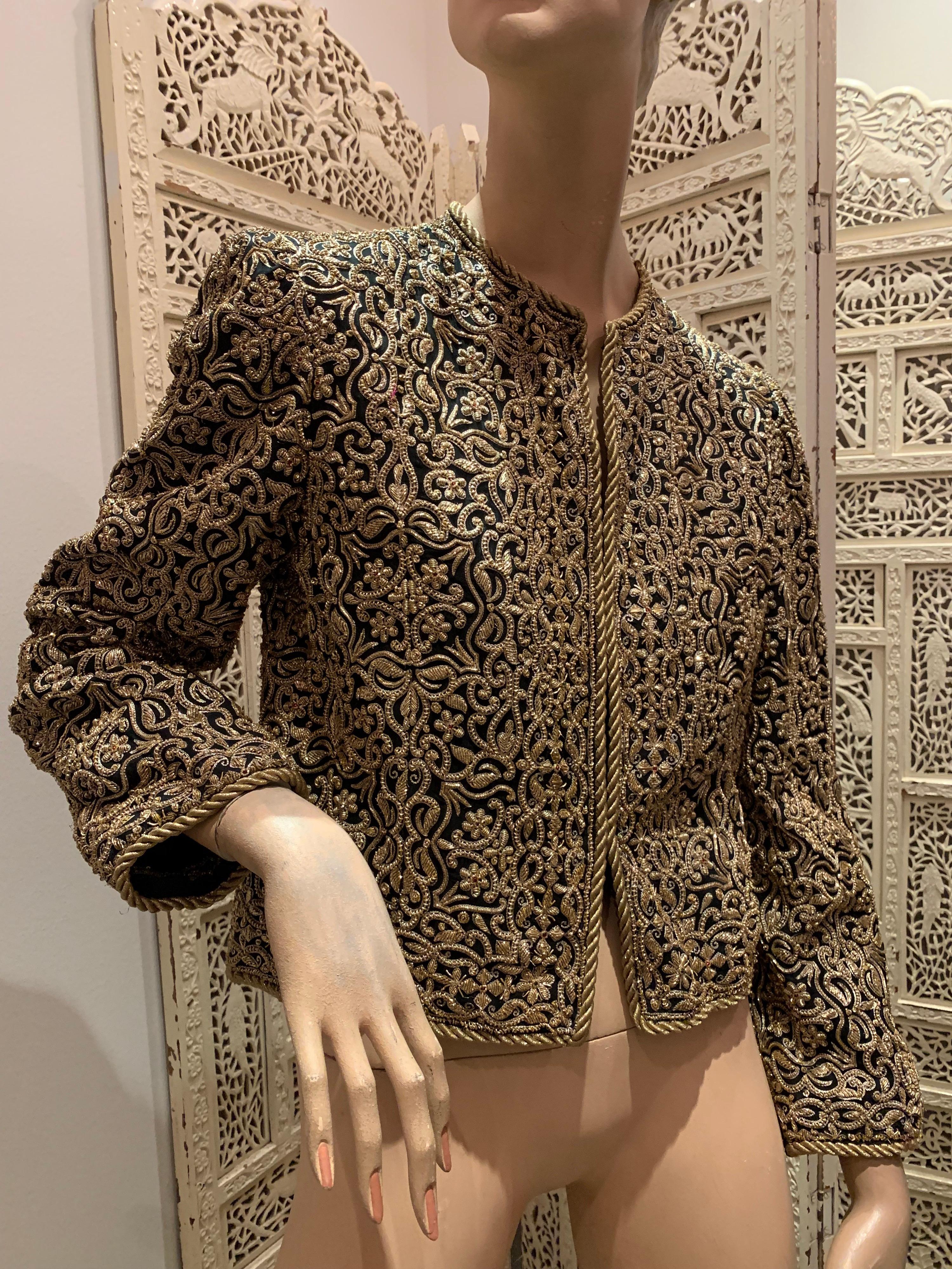 A stunning 1980s Bill Blass evening jacket of traditional Indian inspiration. Heavily encrusted all over with chain embroidery gold work. Imported fabric. Gold roping at hems and cuffs. Fully lined with hook and eye closures.  
