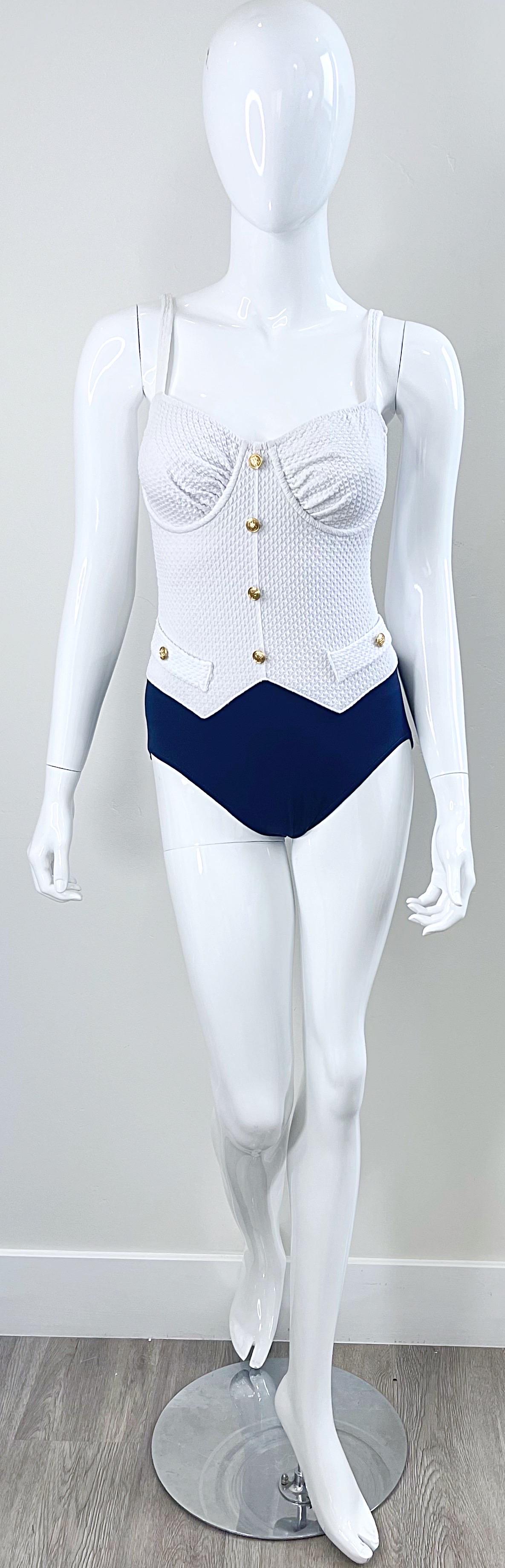 Chic late 80s BILL BLASS navy blue and white nautical inspired one piece swimsuit or bodysuit ! Gold logo BB embossed buttons up the front and at each side of the waist. 
Perfect for the beach, pool or yacht.
In great condition 
Made in