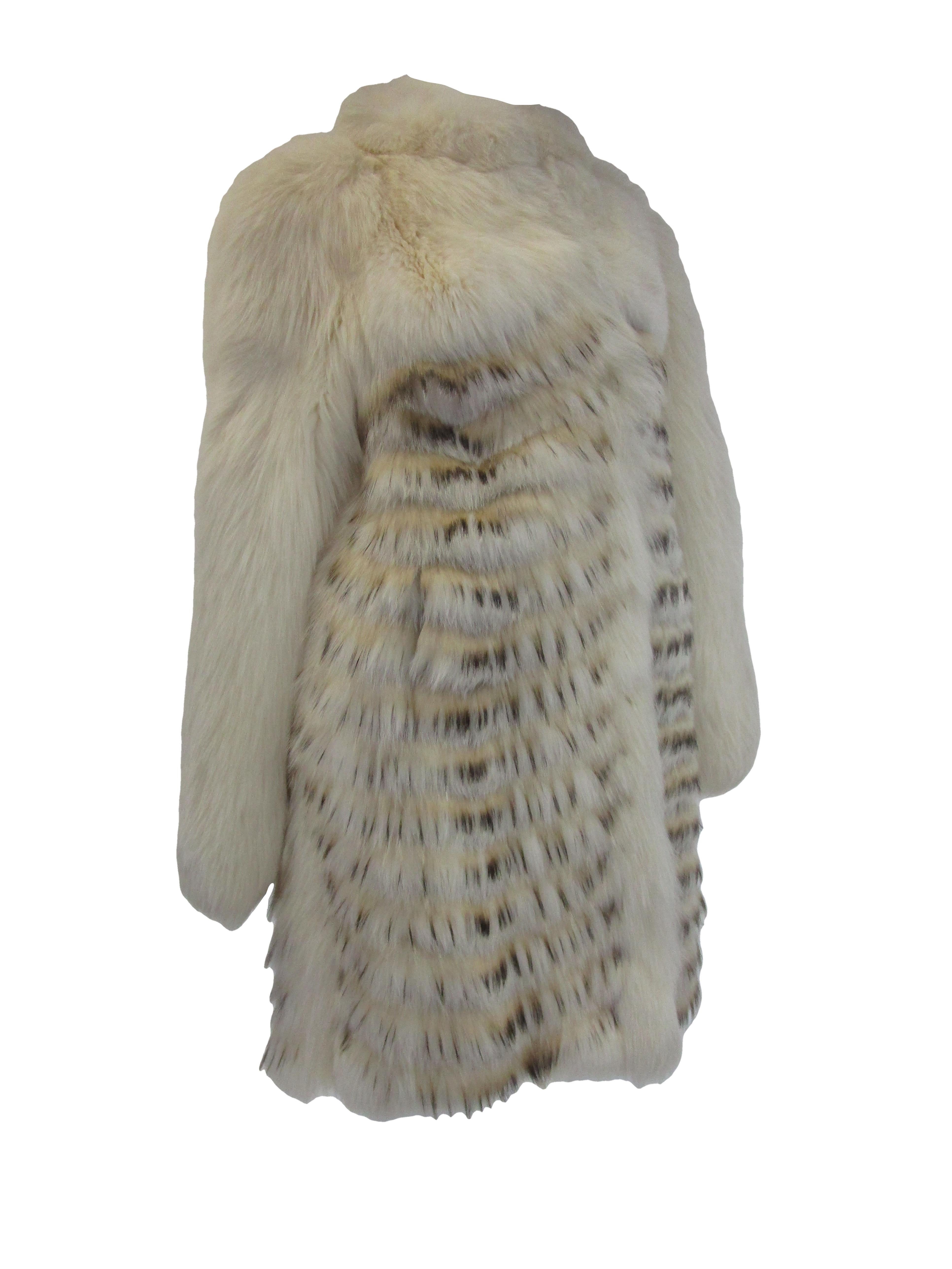  
make a statement this winter with a ravishing fur coat from Bill Blass Paris! Perfect for an evening event or just casually strutting your best look off the slopes! The fur billows around the neck with hues of brown, cream and grey cascading down