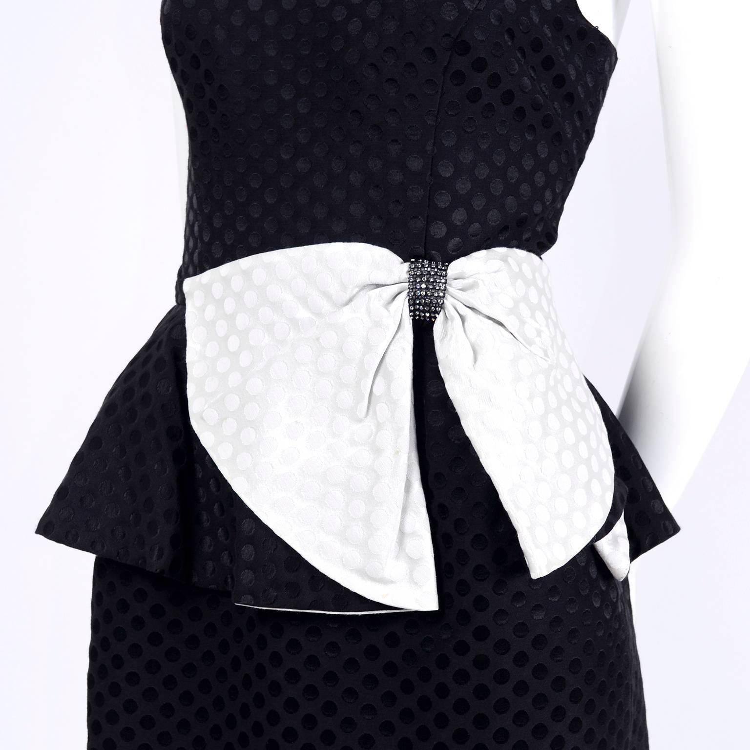 This black and white polka dot vintage dress was made in the 1980’s. The dress is black with tone on tone polka dots with a white tone in tone polka dot bow with rhinestones. The bodice of the dress is lined and there is an 8” slit in the back. We