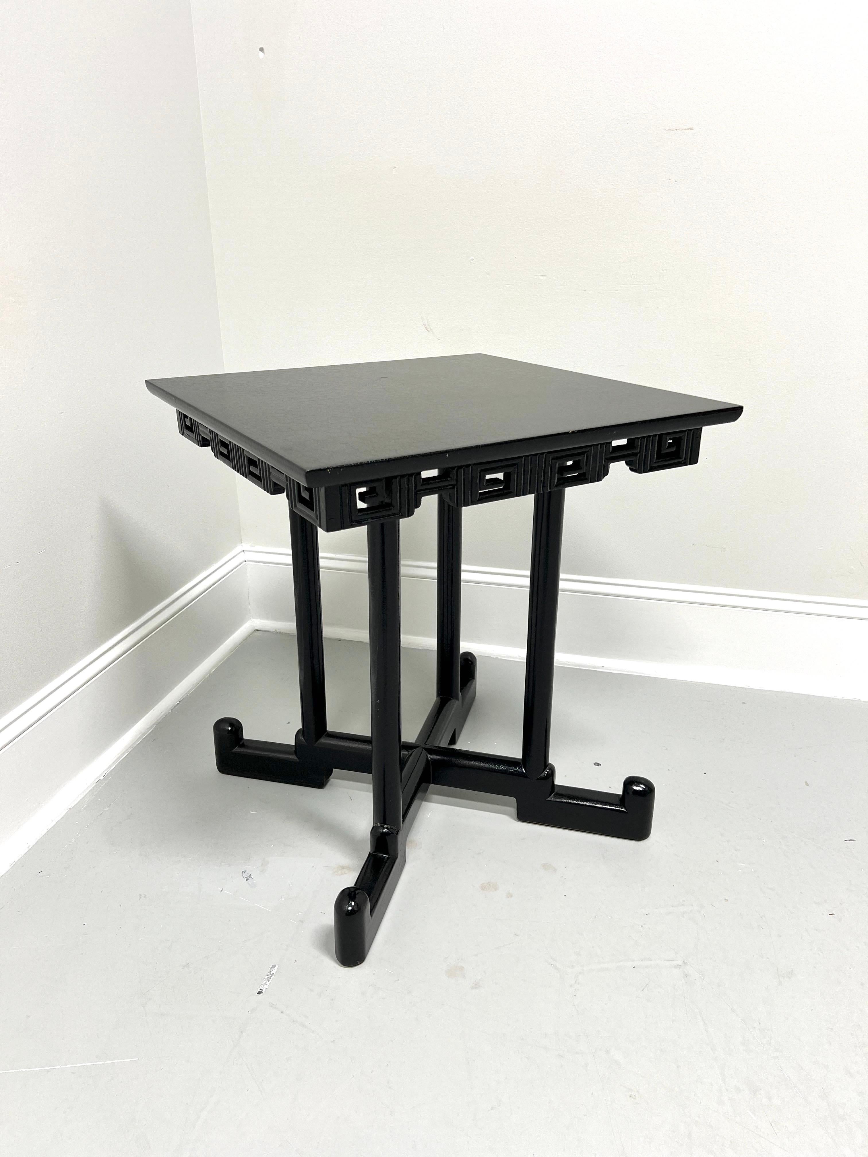 An Asian style square accent table, unbranded. Solid hardwood with a black crackle finish, miter edge to the top, carved decorative Chinoiserie pattern to apron, round straight legs, 