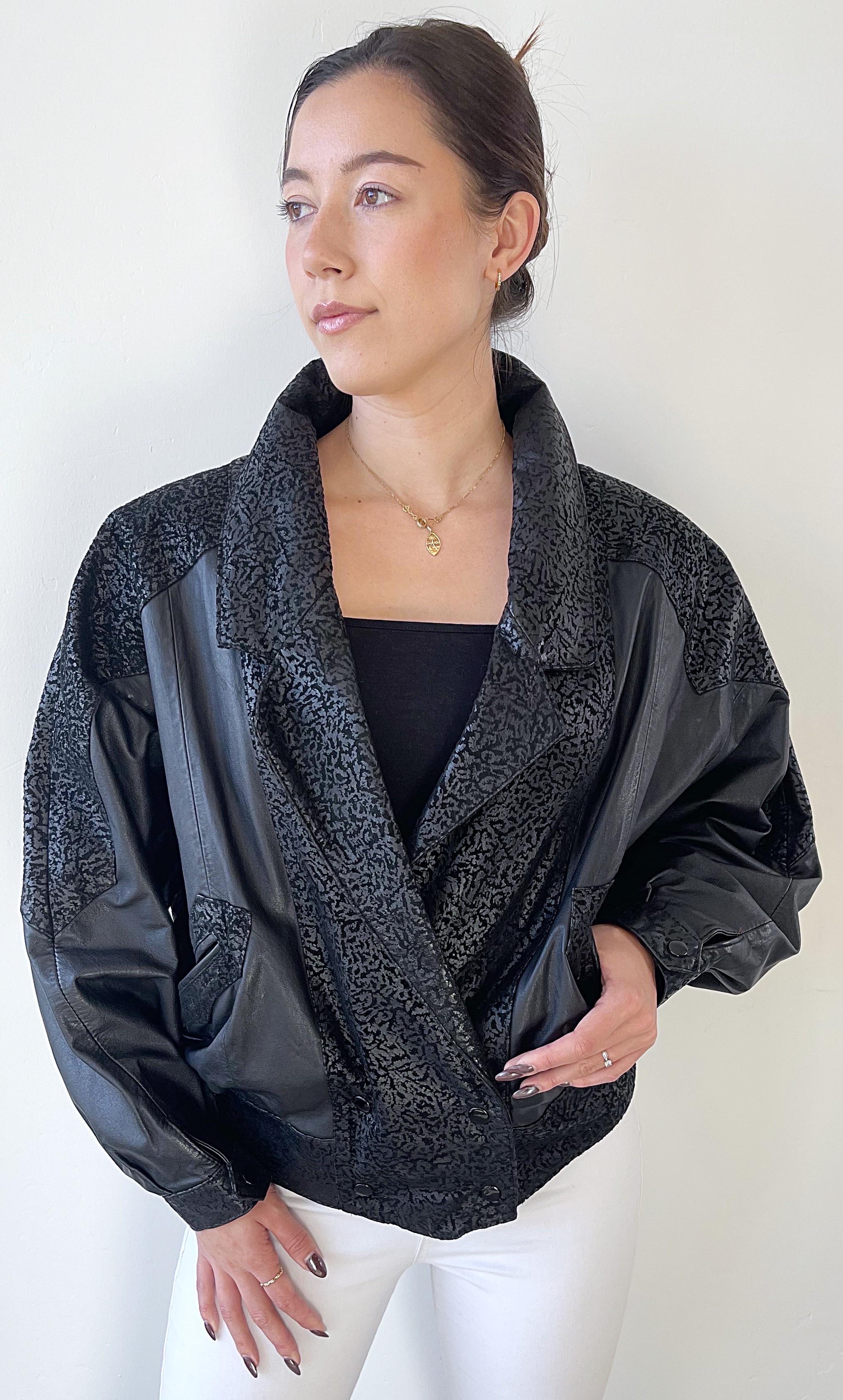 Amazing 1980s black embossed leather dolman sleeve jacket ! Features embossed leather along the collar, on top of the sleeves, and unique pattern on the back. Pockets at each side of the waist. Double breast style with four snaps at the waist. The