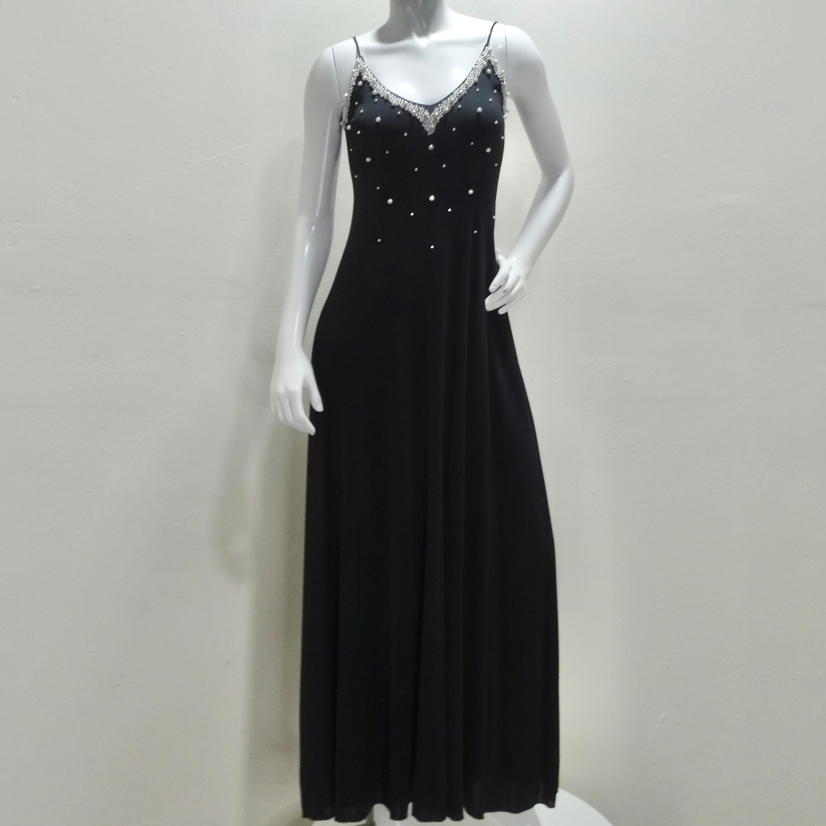 Experience the epitome of vintage glamour with this stunning 1980s Black Pearl Beaded Maxi Dress and Cardigan Set. This ensemble exudes sophistication and timeless charm, featuring an exquisite slip-style black maxi dress adorned with clusters of