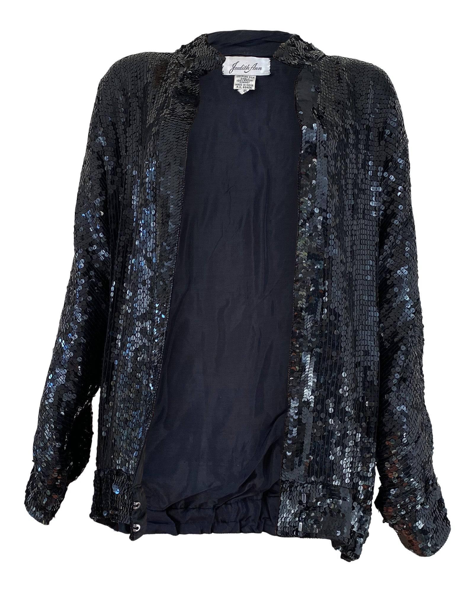 What a fun piece! You'll adore the multiple styling options of this festive 1980s silk sequined jacket - wear it alone as a shirt, open as a cardigan, or fully closed to show off the banded collar and dolman sleeves. The perfect piece for the