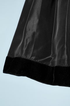 1980's black velvet and taffetas dress with rhinestone piping.