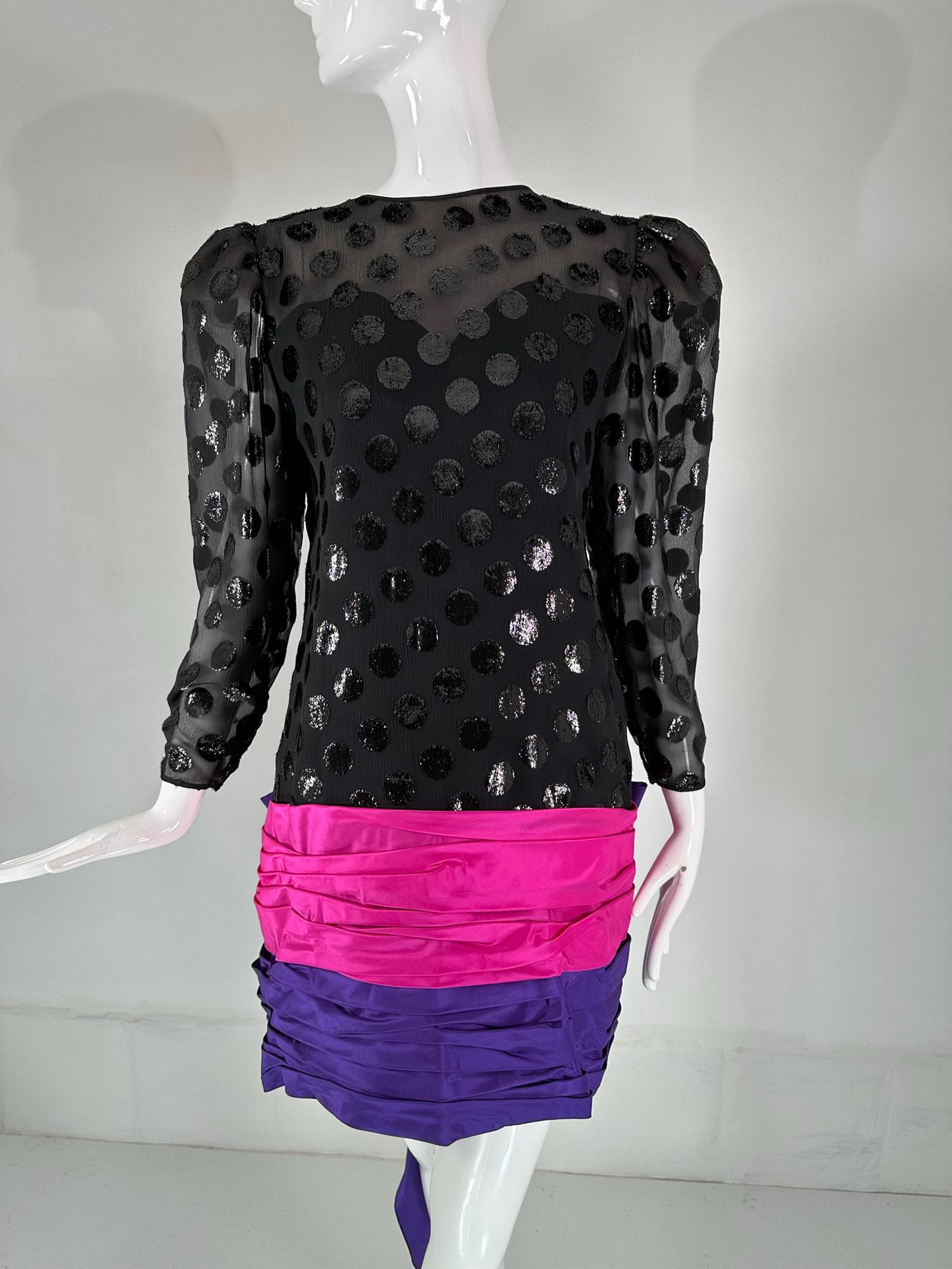 1980s Black cut velvet with large sparkly velvet dots. V back neck with horizontally draped pink & purple taffeta skirt and a huge bow at the hip back. LA fabulous party dress from the 1980s. Long sleeves with a poof shoulder that tapers to the