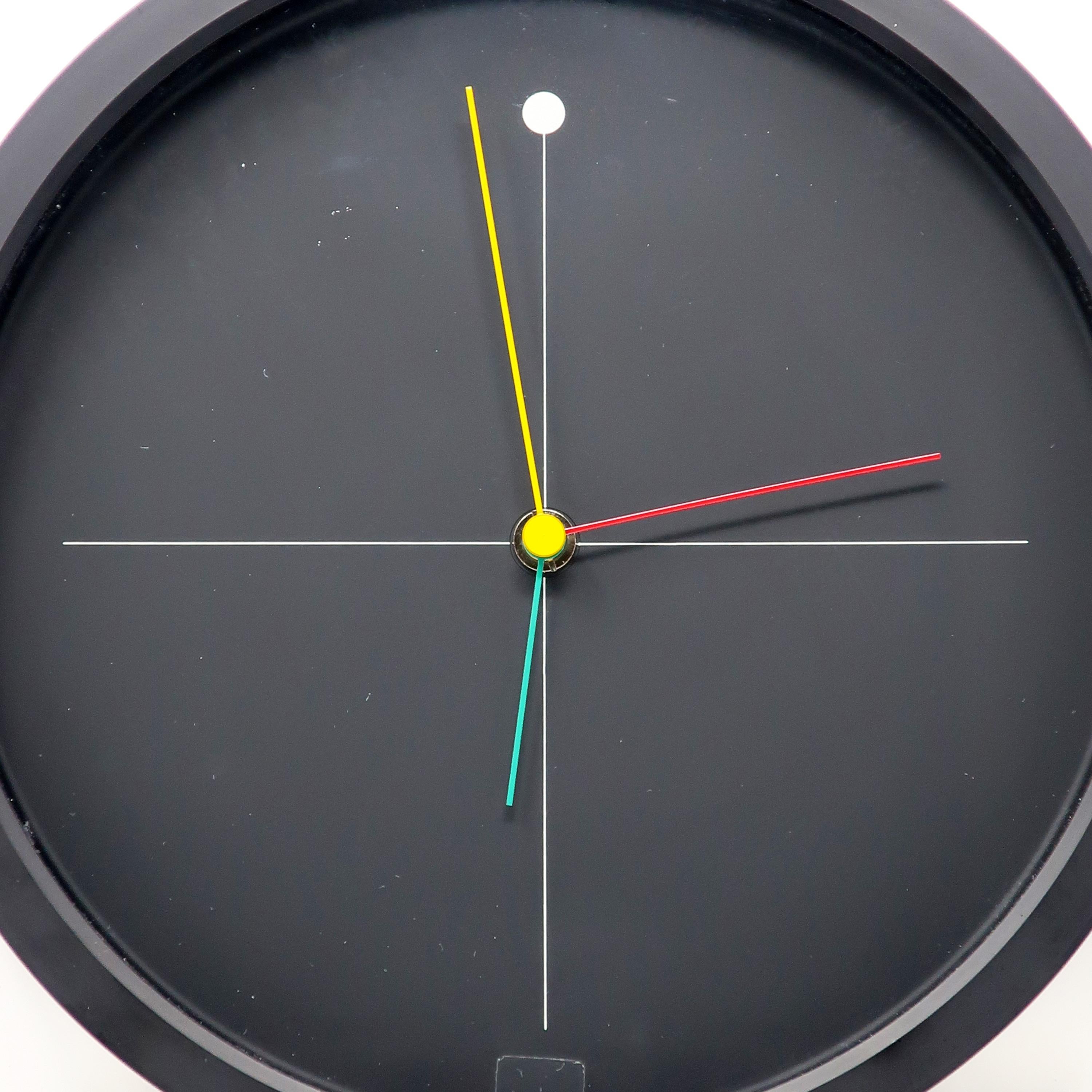 A perfectly elegant and sophisticated 1980s wall clock designed by Shohei Mihara for Wakita. Postmodern, Memphis-influenced design at its finest! Black with white, red, green, and yellow accents. Battery operated and works great.

In very good