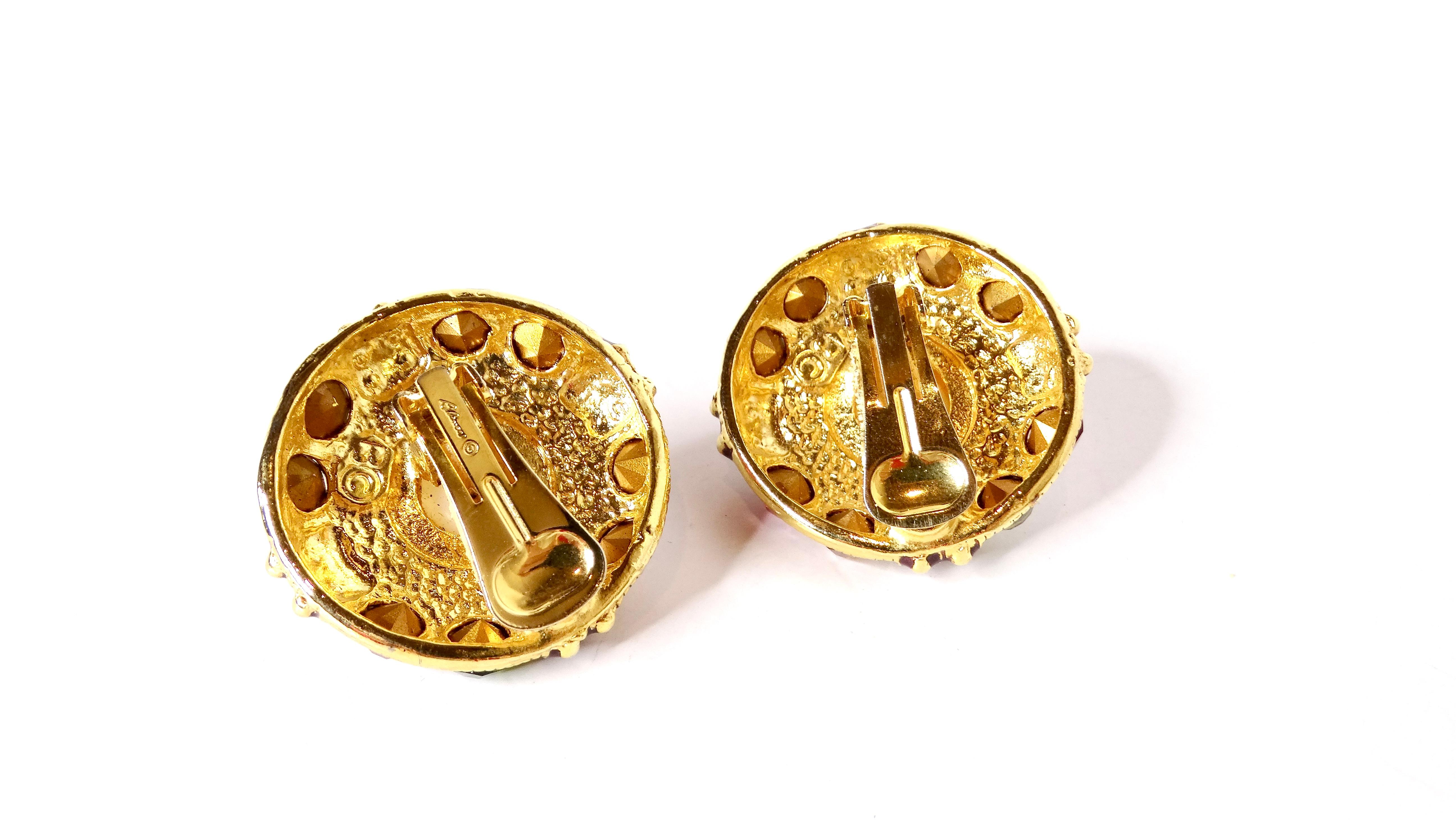 Step back into the vibrant era of the 1980s with these stunning Blanca Large Costume Bejeweled Enamel 14k Gold Plated Clip-On Earrings. These eye-catching accessories feature a lustrous faux pearl center, elegantly surrounded by an array of dazzling