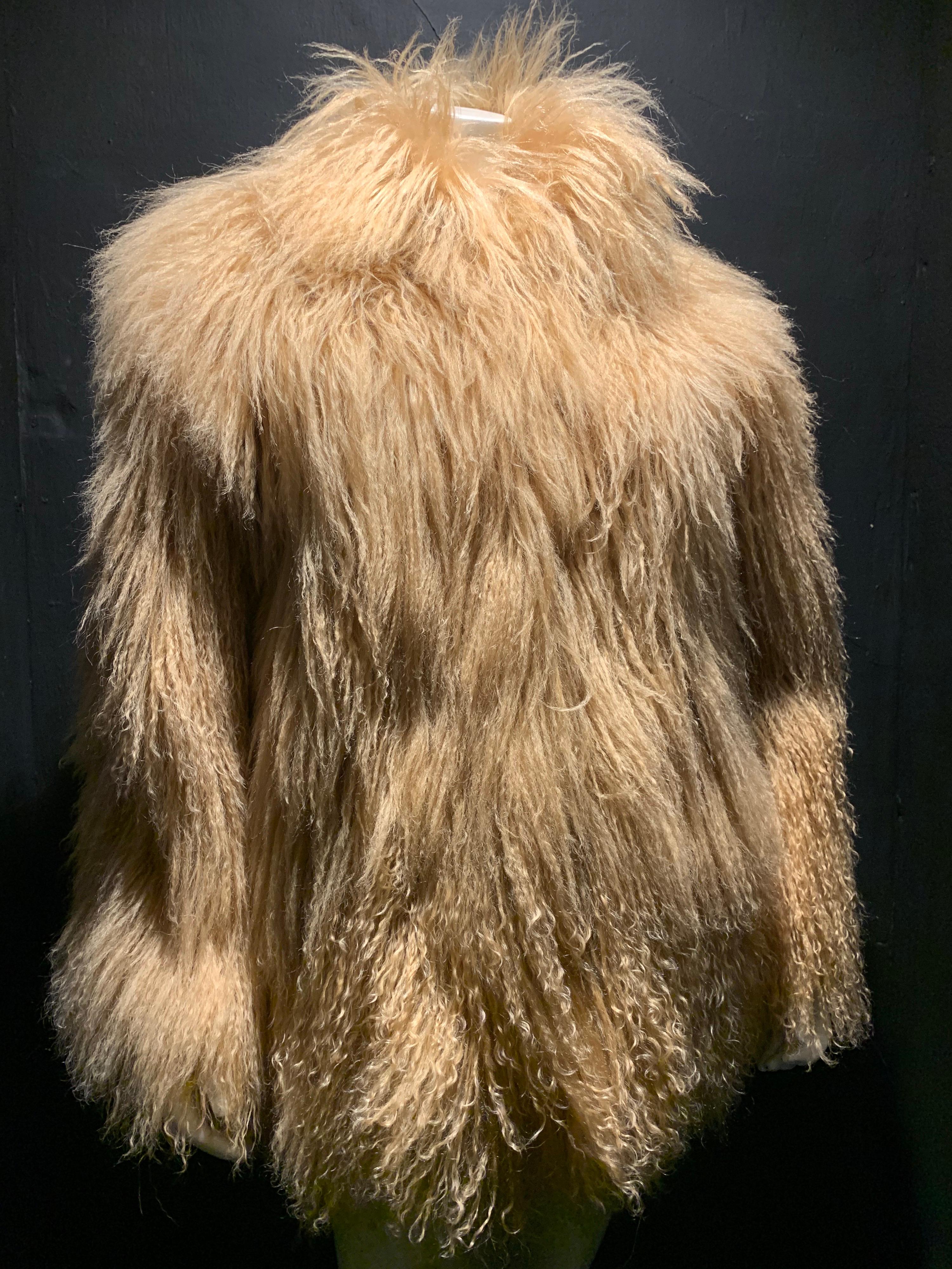 A fabulous 1980s caramel color Mongolian mid-thigh length lamb coat from Bloomingdales. Satin lined. 