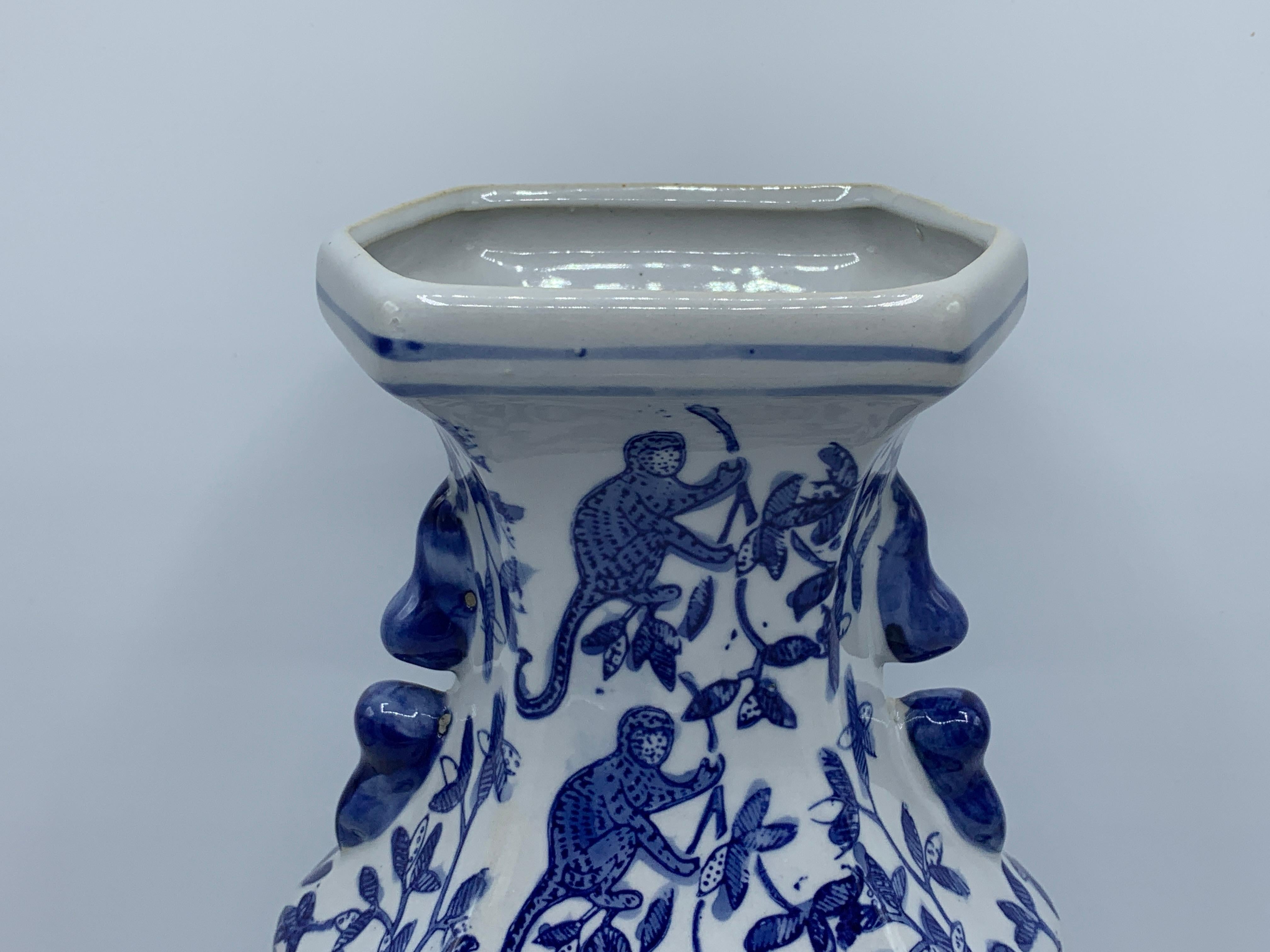 Offered is a gorgeous, 1980s chinoiserie blue and white vase. The piece has a unique and whimsy climbing monkey motif all-over. Heavy, weighing 3.5lbs.