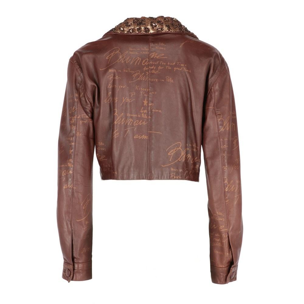 Blumarine by Anna Molinari brown leather jacket. Classic lapel collar with bronze and gold spotted paillettes and seed pearls. Long sleeves with buttoned cuffs. Side zipped closure and two welt pockets.

Size: 40 IT

Flat measurements
Height: 45