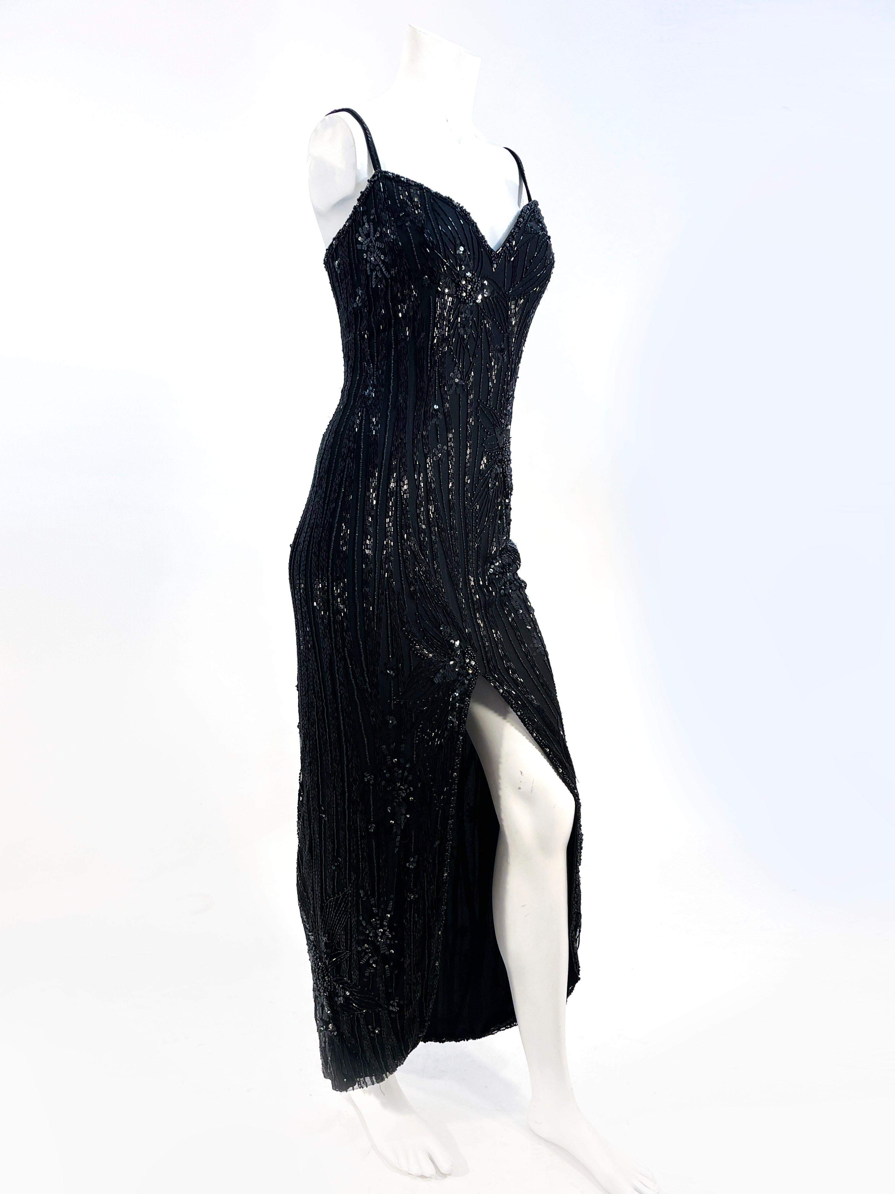 1980s Bob Mackie black evening gown featuring an abstract floral motif in glass bugle beading, sequin, and rhinestone. The bodice has a sweetheart neckline, narrow velvet and sequin straps, padding, and interior boning providing structure down to