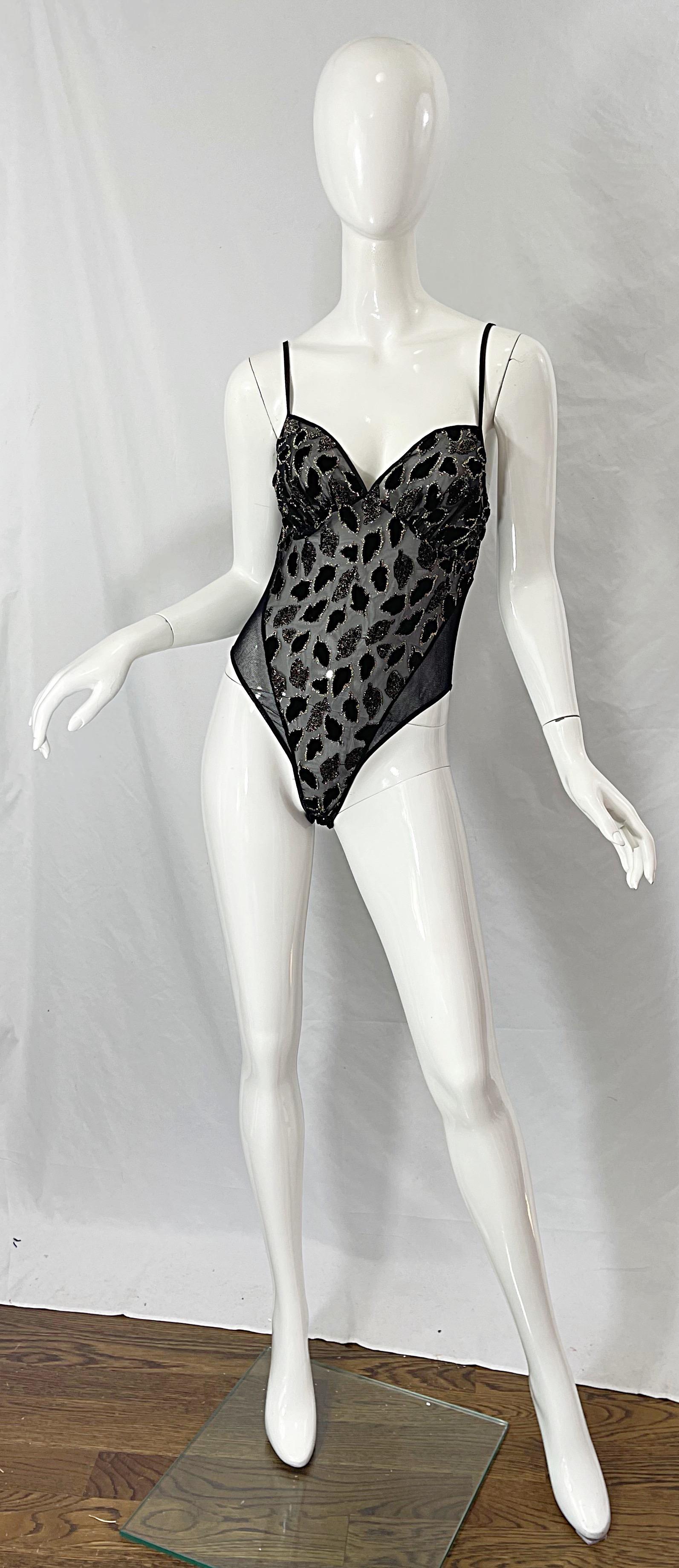 Sexy early 80s BOB MACKIE black and gold leaf motif mesh and cut-out burnt velvet one piece sheer bodysuit ! I love the variety of fabrics on this rare gem. Can easily be dressed up or down. Pair with shorts, jeans, trousers or a skirt.
In great
