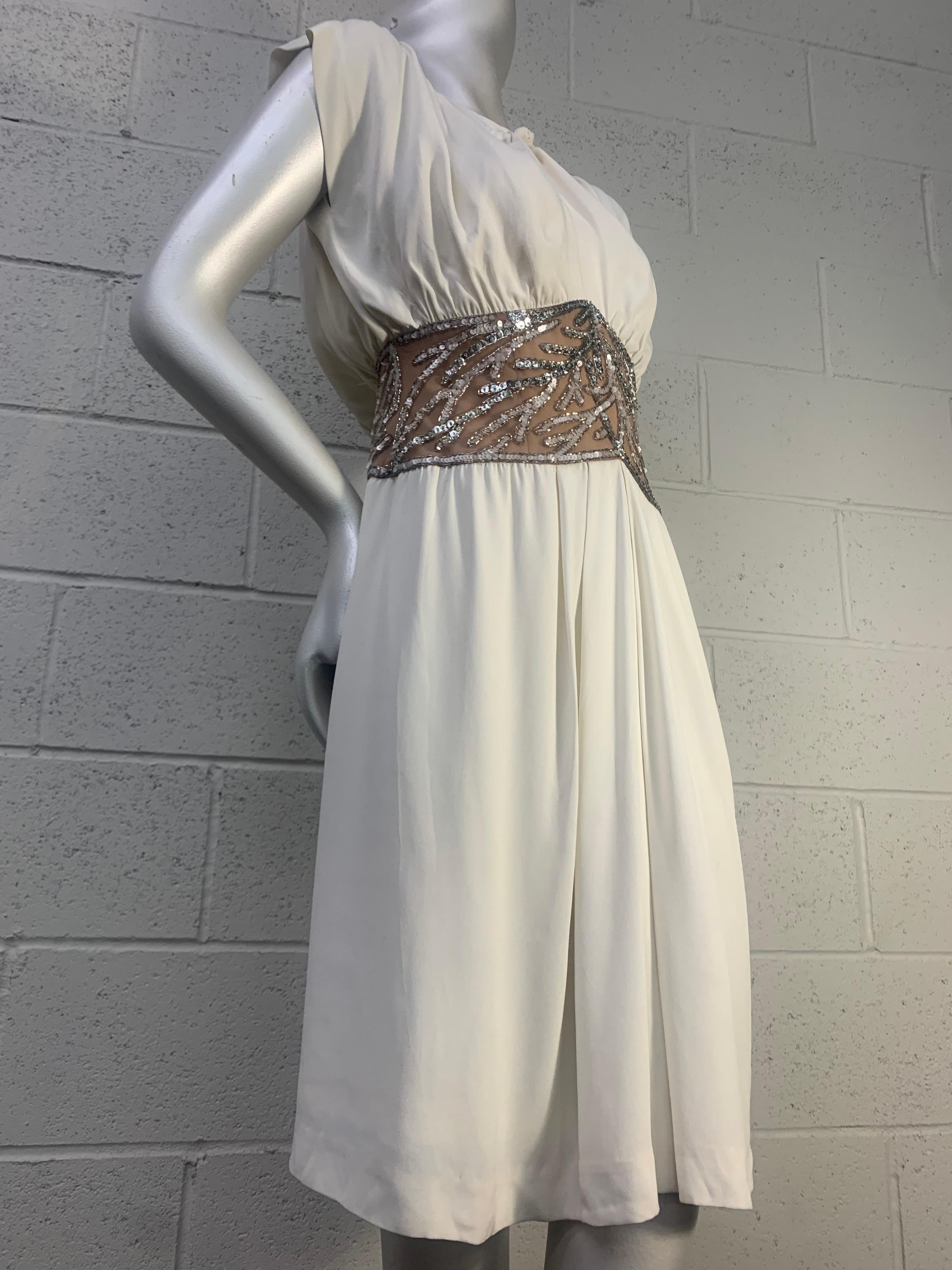 1980s Bob Mackie White Silk Crepe Cocktail Dress w Sheer Beaded Waist Panel: 1940s inspired silhouette with keyhole knotted front neckline, blouson sleeve and back. Slightly gathered skirt. Wide waist panel in sheer illusion and coral motifs in