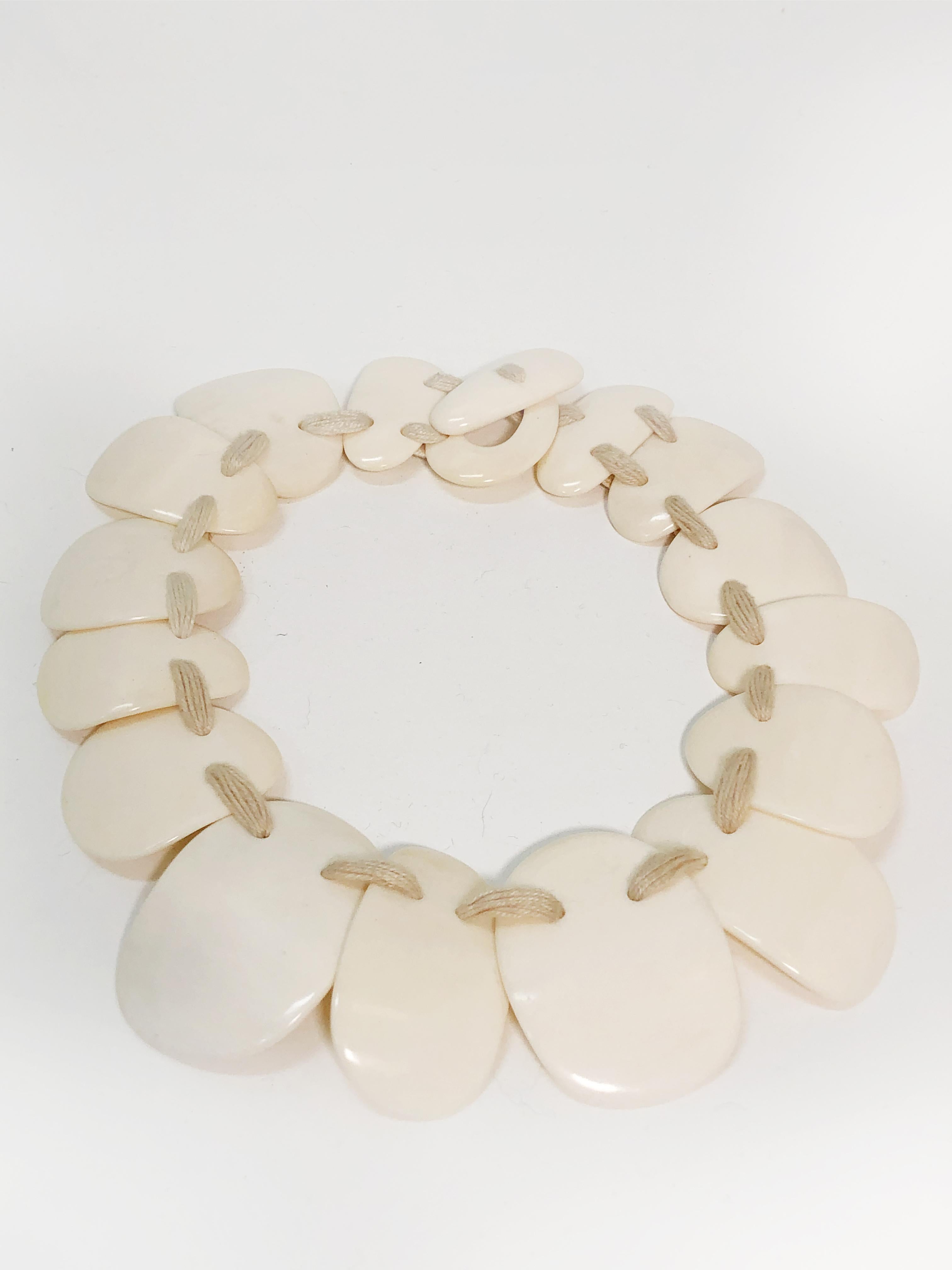 1980s wafer bone disc collar necklace strung with waxed cotton.  Toggle closure. Graduated in size.  18