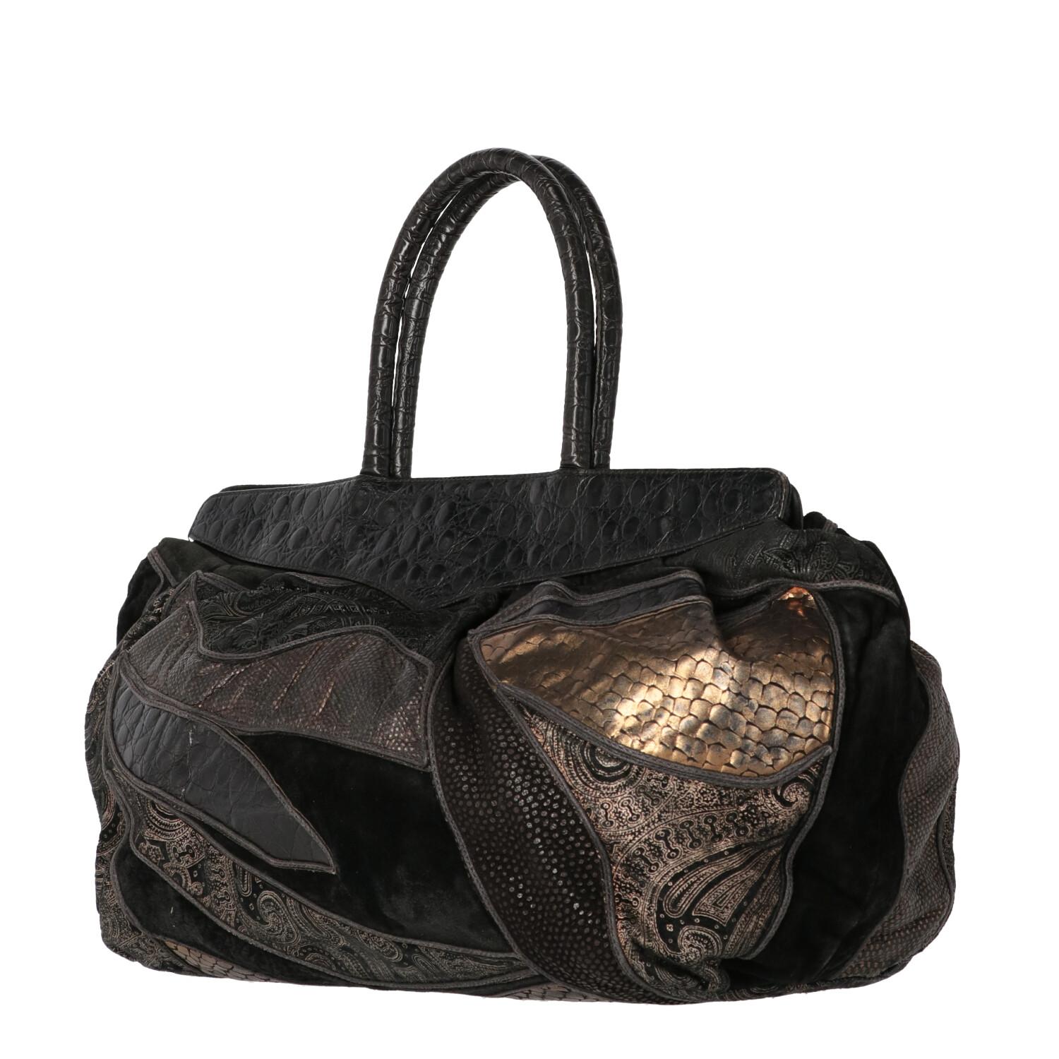 A.N.G.E.L.O. Vintage - ITALY 
Braccialini black leather with patchwork motif bag and different patterns in shades of gold. Model with double leather handles and button closure. Fully lined in leather with internal pockets.
Years: 80s

Made in