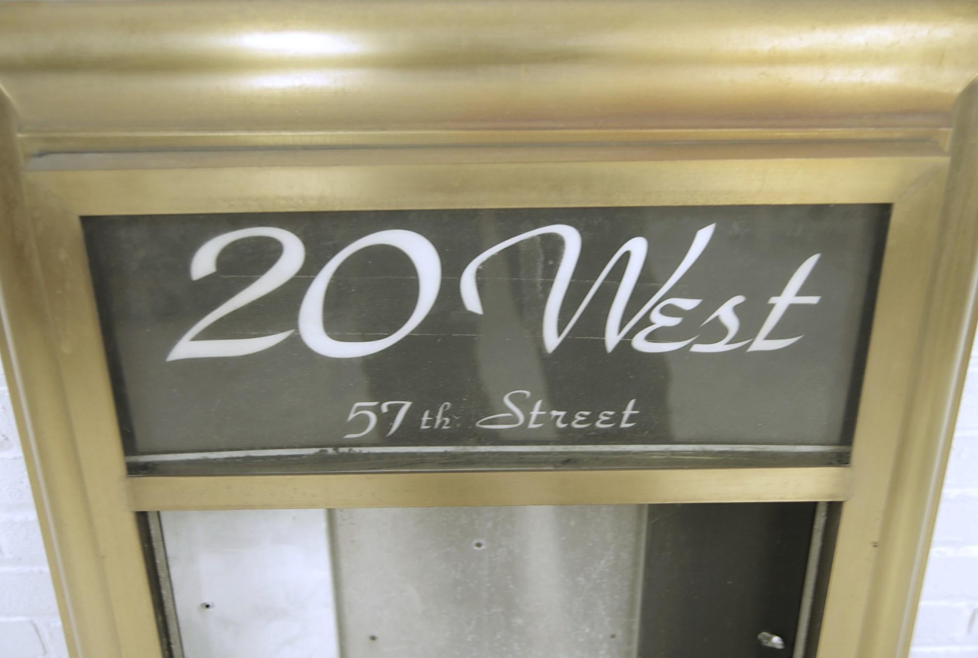 1980s reclaimed building directory or registrar from 20 West 57th St made of brass and aluminum.