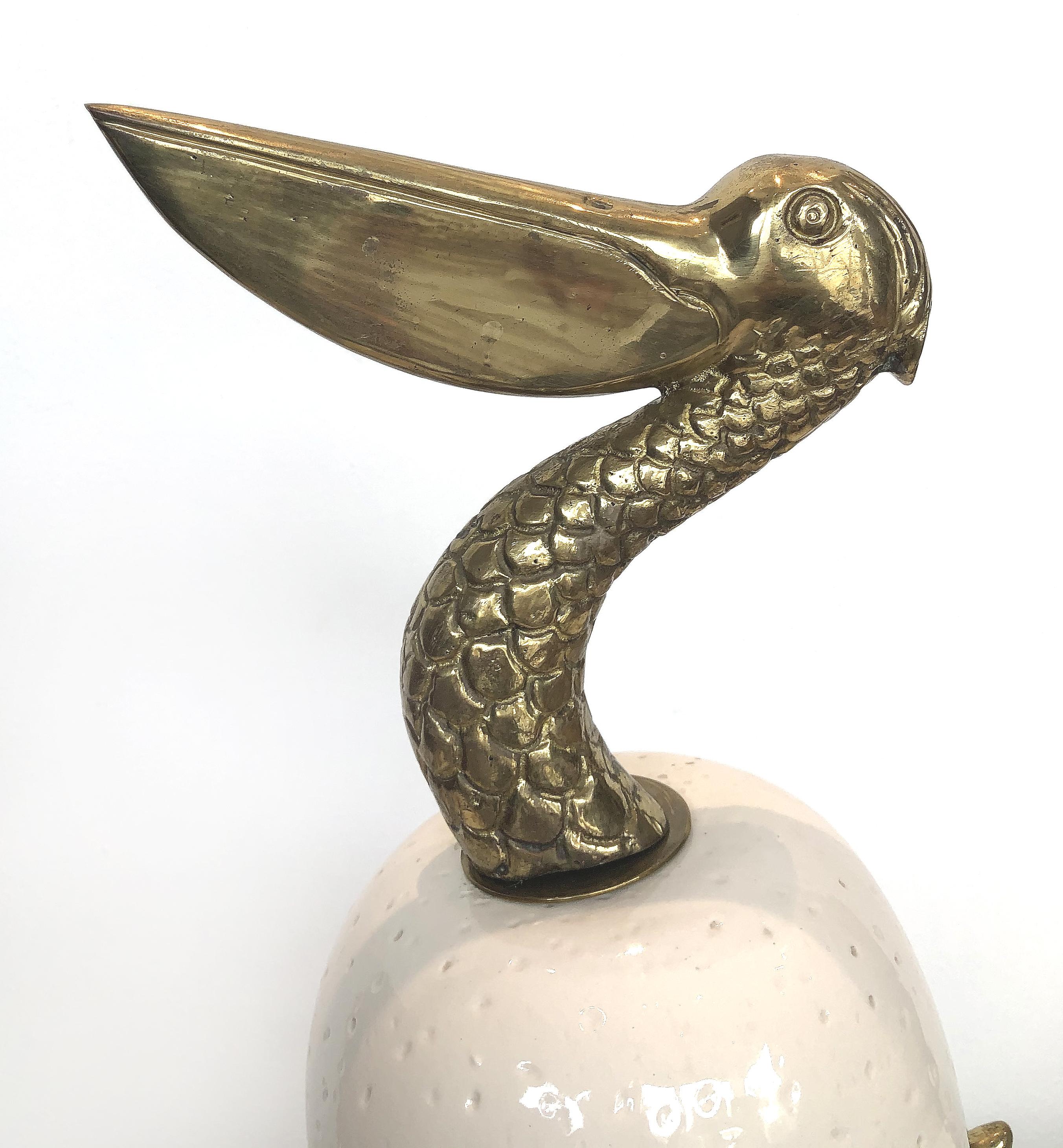 1980s, brass and glazed pottery pelican sculpture

Offered for sale is a 1980s vintage pottery pelican sculpture with brass details presented on a Lucite base. The pottery form is exquisitely glazed. The head, neck, and legs are brass.
   