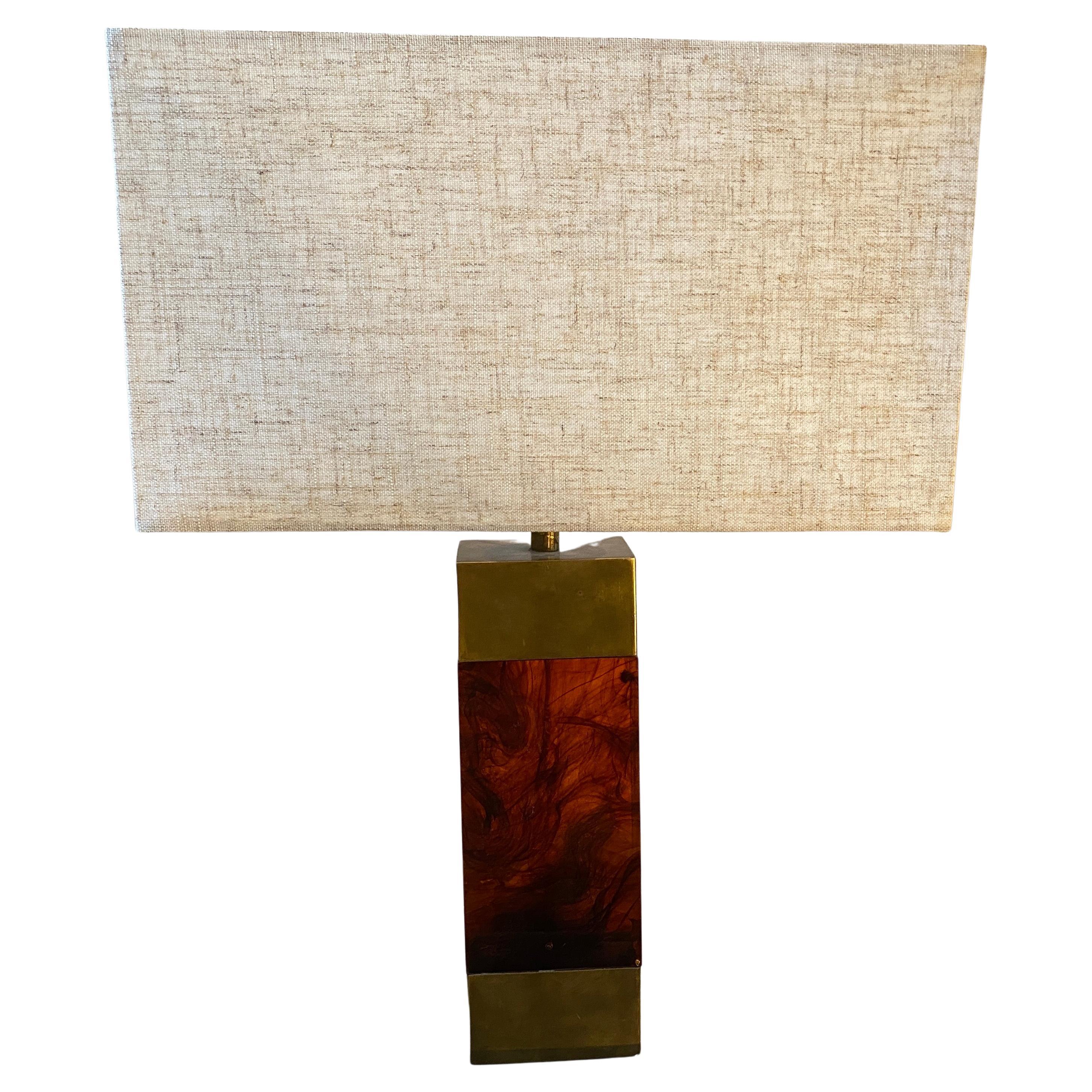 A brass and lucite table lamp designed and manufactured in Italy in the Seventies in the manner of Christian Dior Home, Signs of use and age visible on the photos, height without lampshade is 36 cm. It works both 110-240 volts and needs a regular