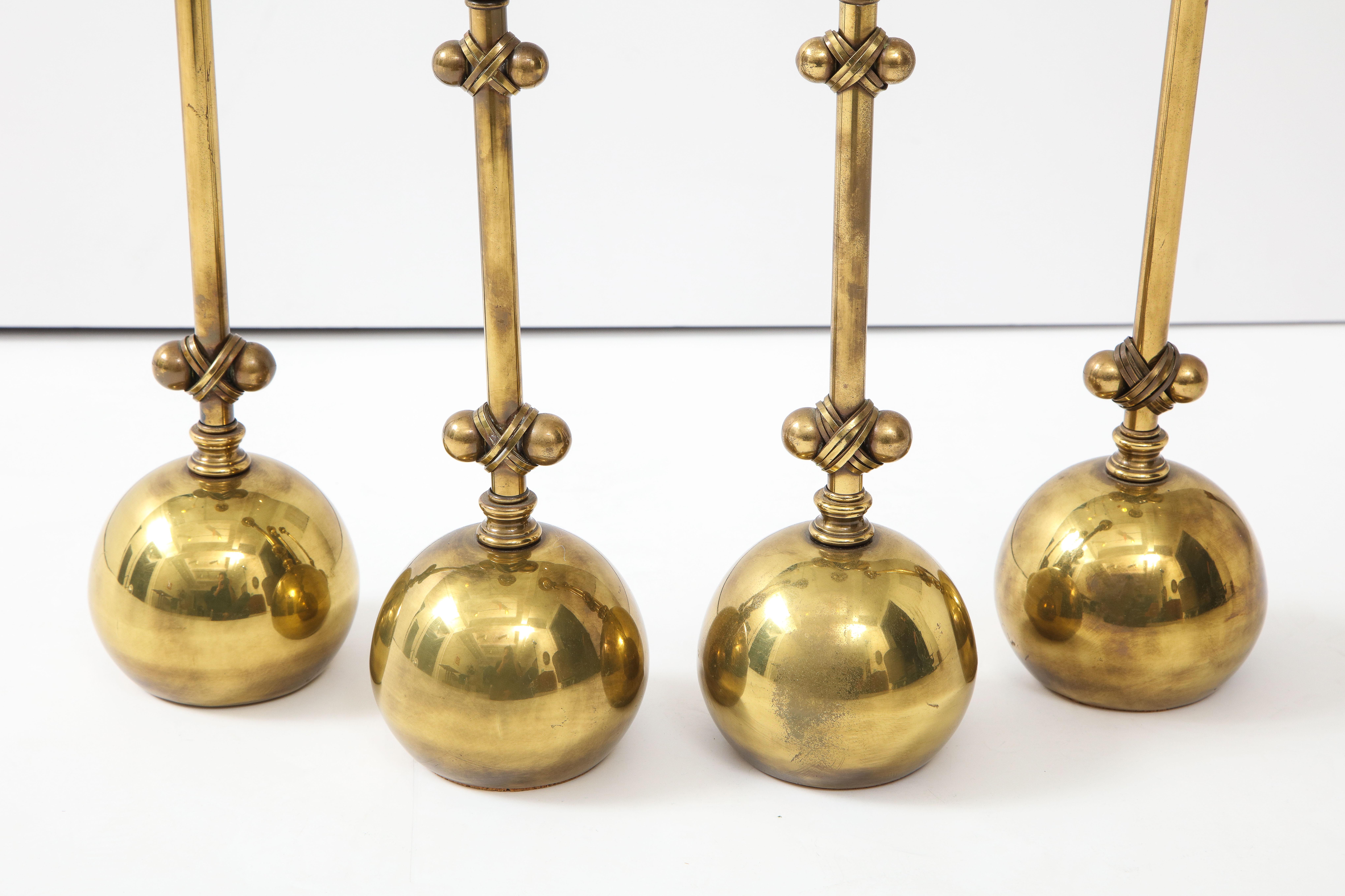 1980s modern brass candleholders in vintage original condition with some wear and patina to the brass attributed to Chapman.

Measures: Smaller candleholders height 13.25, width 4.