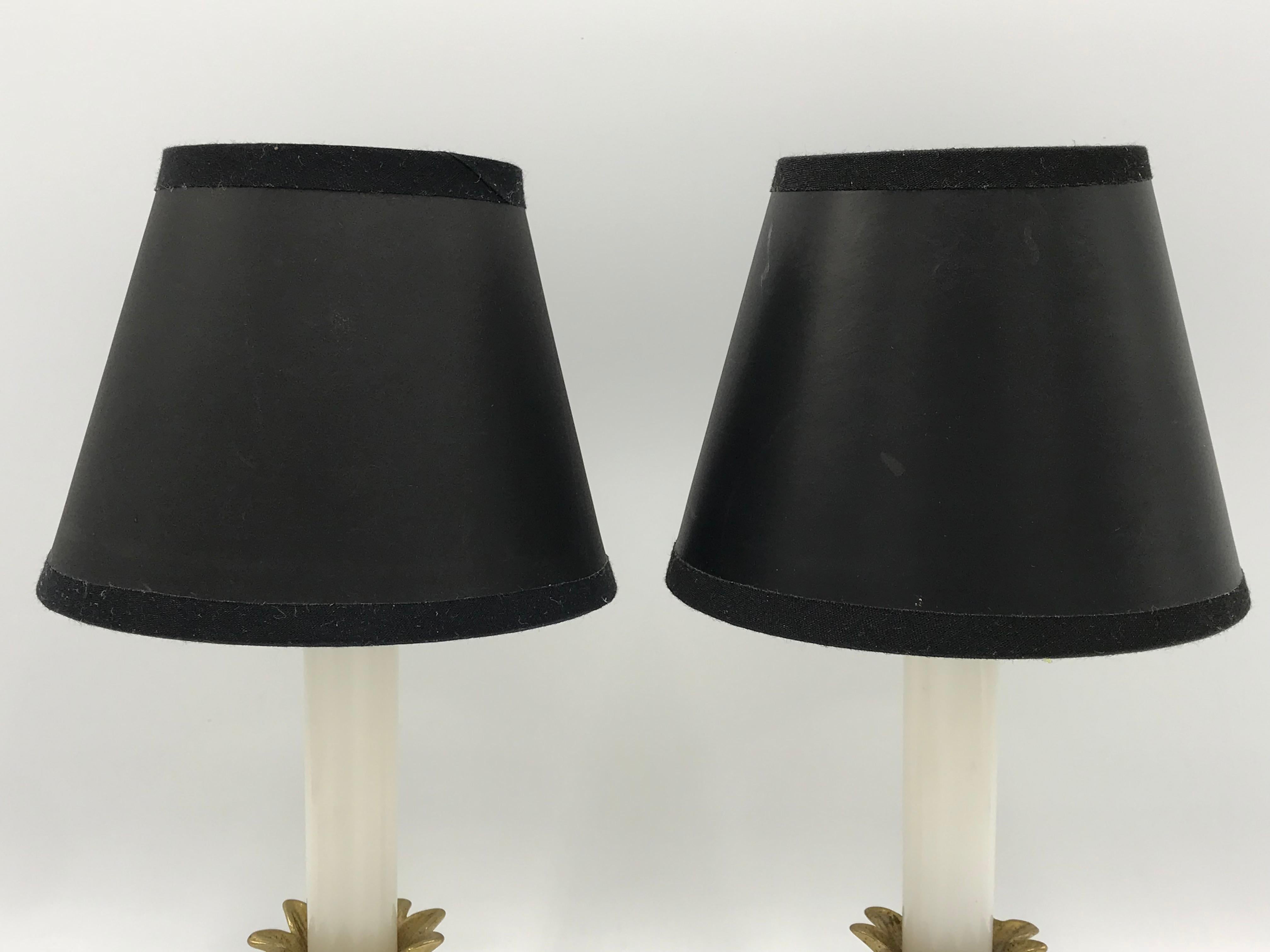 Offered is a fabulous, little pair of 1980s brass pineapple sculptural candlestick lamps. The pair includes black paper shades (minor wear, expected with age). Wiring is in excellent, working condition. Diameter with shades is 5in. Diameter without