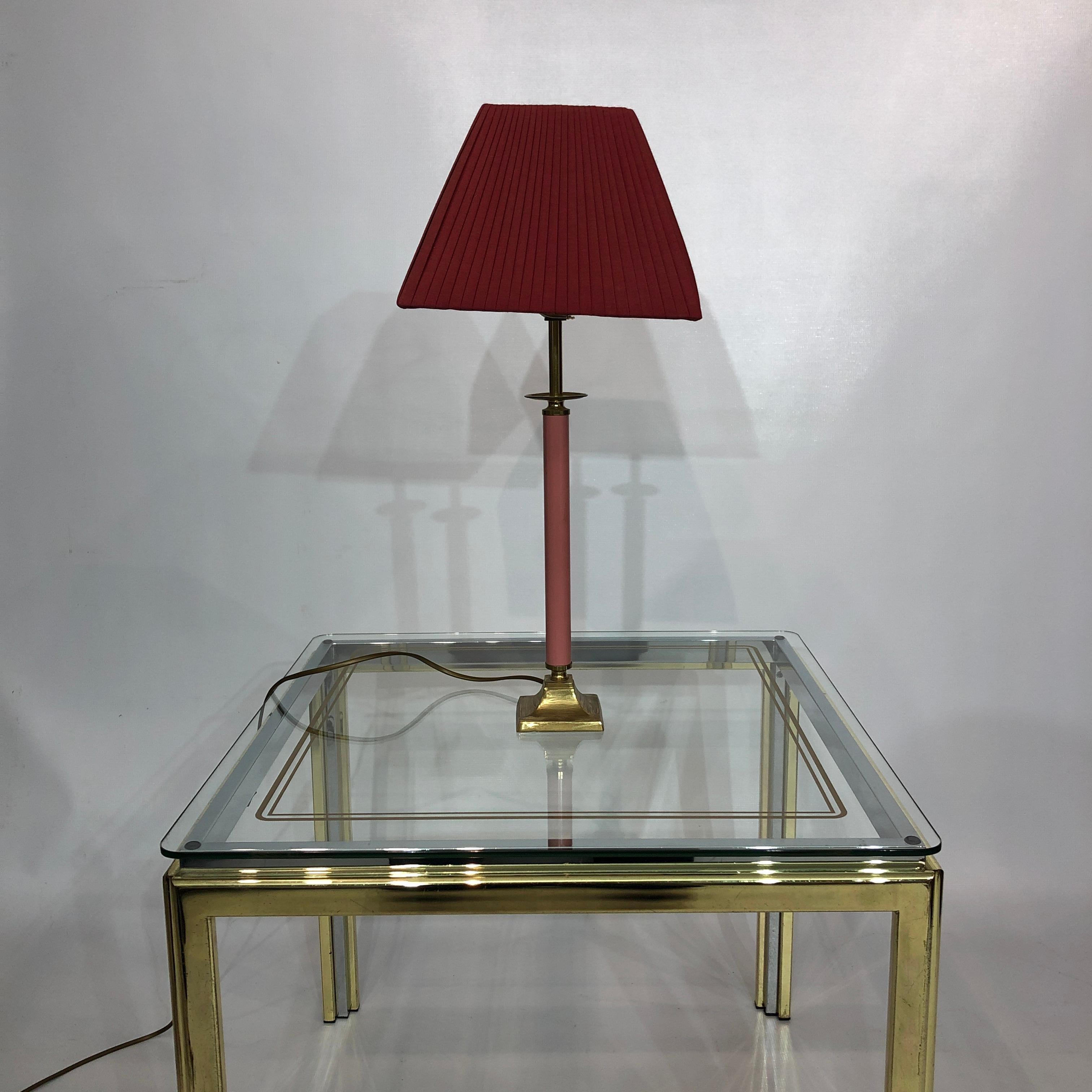 A lovely brass and millennial pink pastel enamel table lamp, with a burgundy pyramidal pleated lampshade. This piece would make a wonderful retro addition to any home either for a hallways, bedside table or kids room.

From a polished brass base