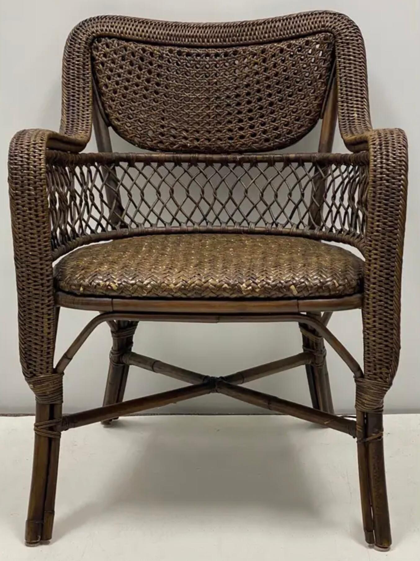 This is a pair of double caned and wicker arm chairs with British colonial styling by Palecek. They are marked and in very good condition.
