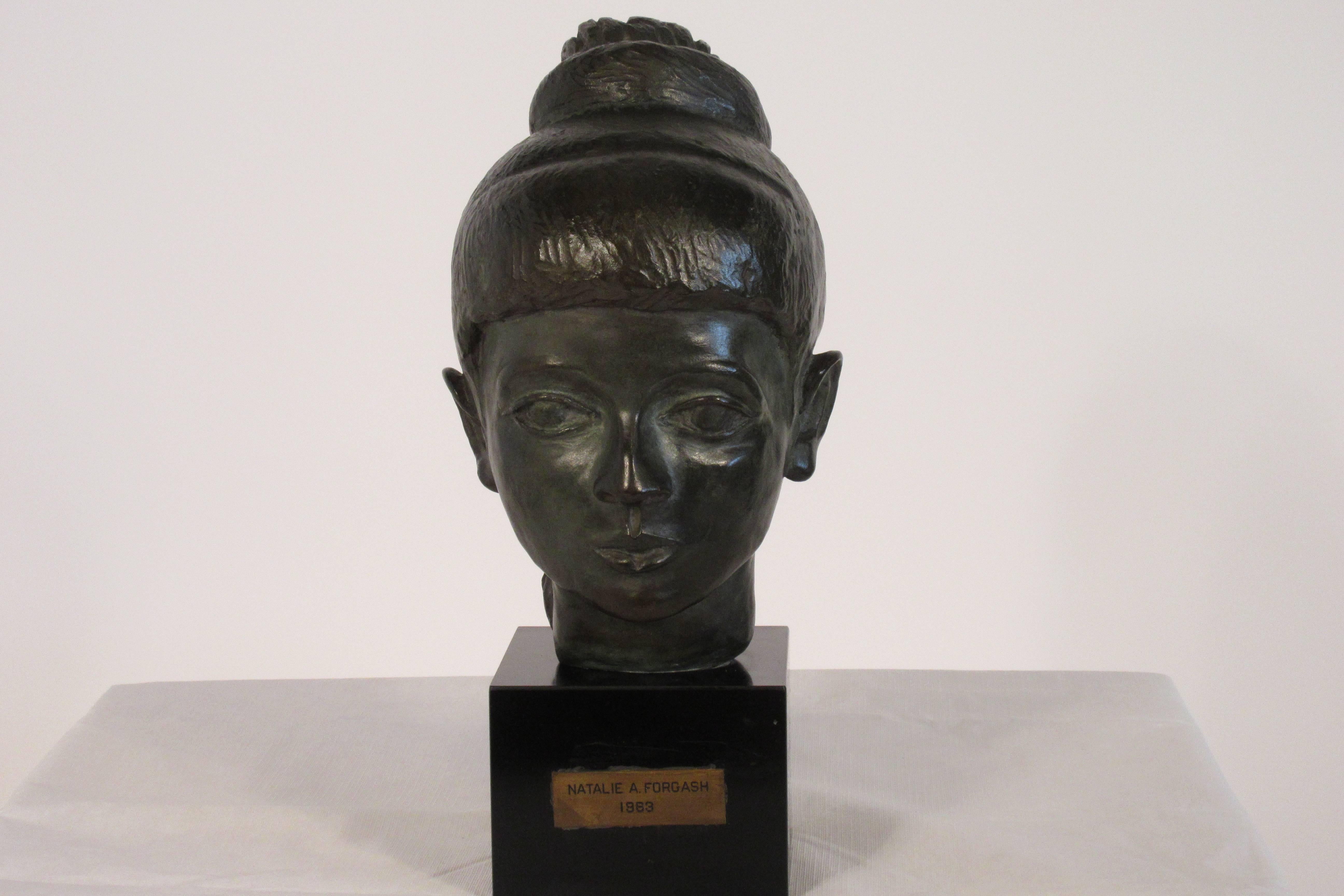 1980s bronze bust of female on wood base and tagged.