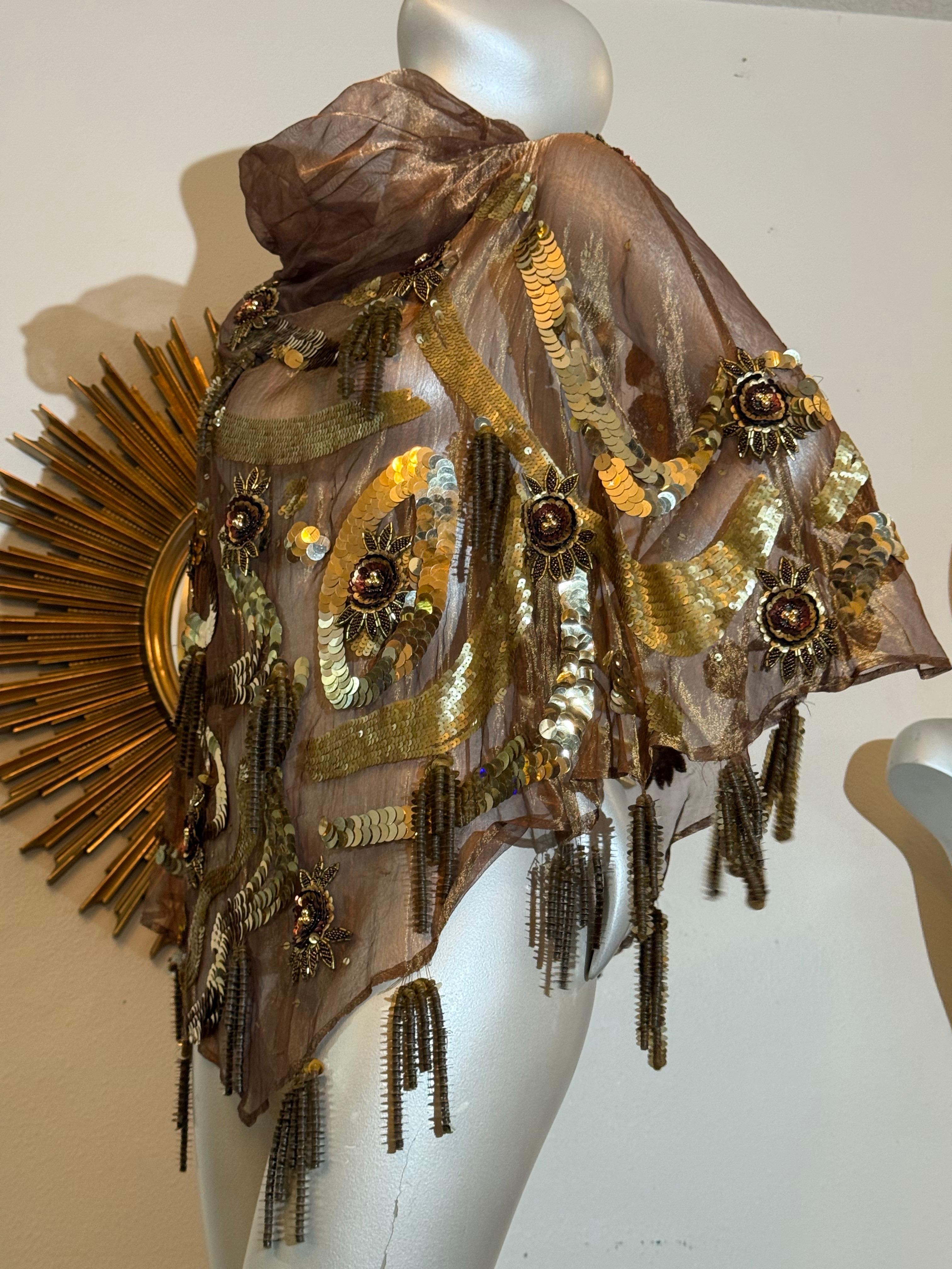 1980s Bronze Metallic Organza Poncho w Extraordinary Beading & Sequins w Fringe:  
This extravagant custom-made, hand-beaded and sequined sheer silk organza poncho is absolutely gorgeous and functions as jewelry!  An exuberant pastiche of shapes and