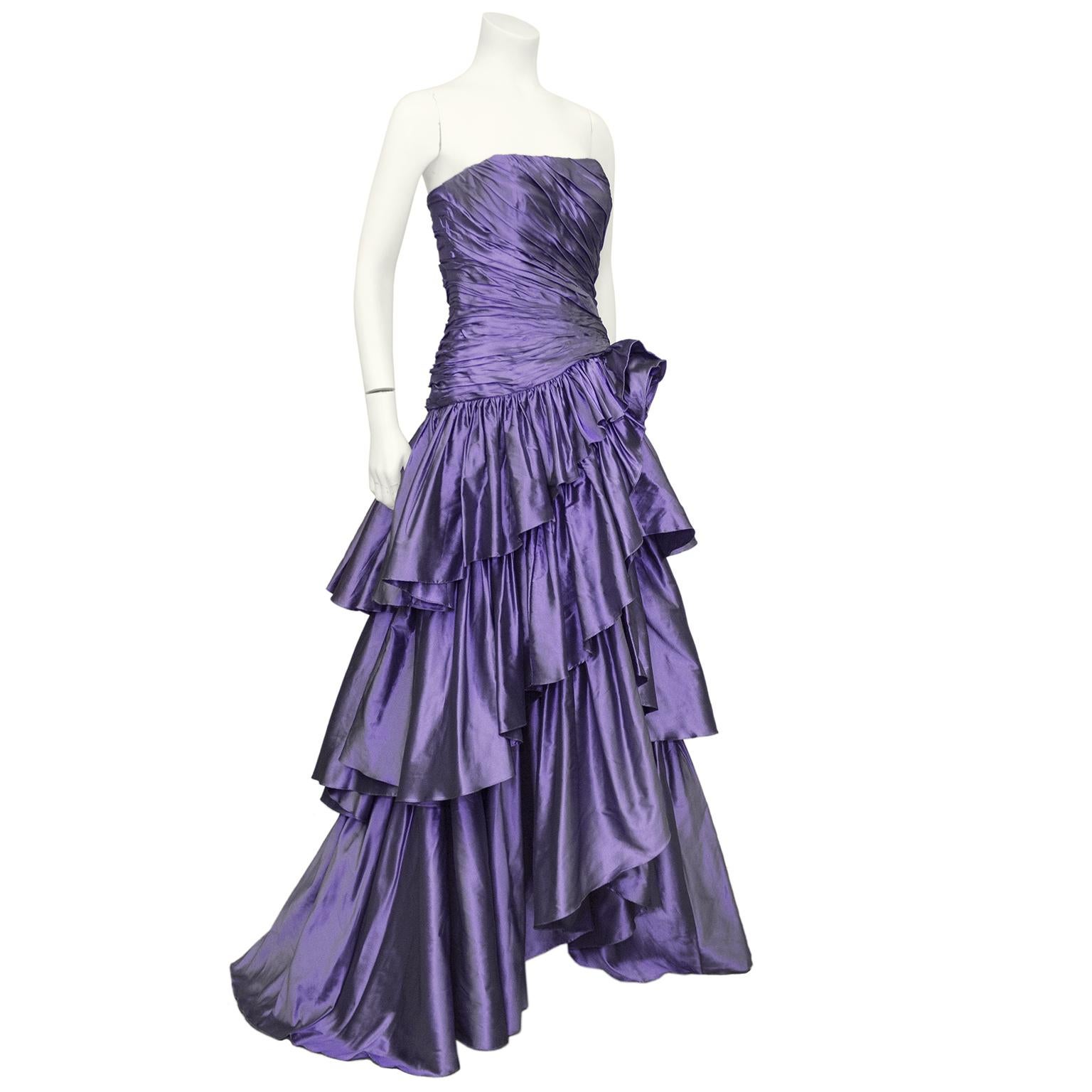 Over the top 1980s glam Bruce Oldfield Haute Couture purple silk taffeta gown. Strapless with ruched drop waist fitted bodice. Skirt features a large rosette that cascades into three tiered layers of perfectly draped purple taffeta. Excellent