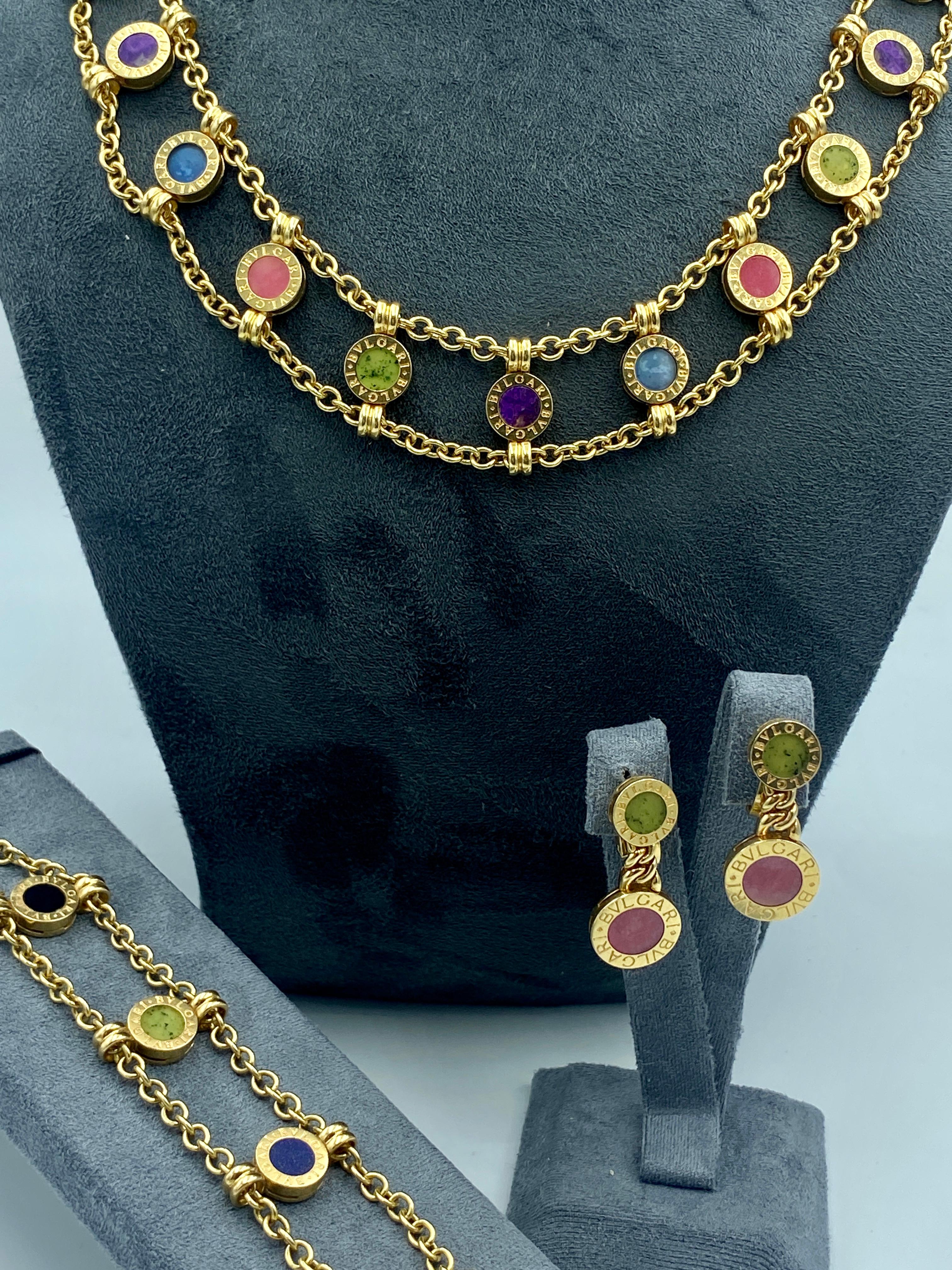 This Bulgari 18k gold chain necklace, bracelet and drop earring set is adorned with a variety of gemstones.

The necklace measures 1.9cm X 38cm and weighs 77.08g.
The bracelet measures 1.9cm x 16.5cm and weighs 26.14g.
The earrings measure 1.3cm X