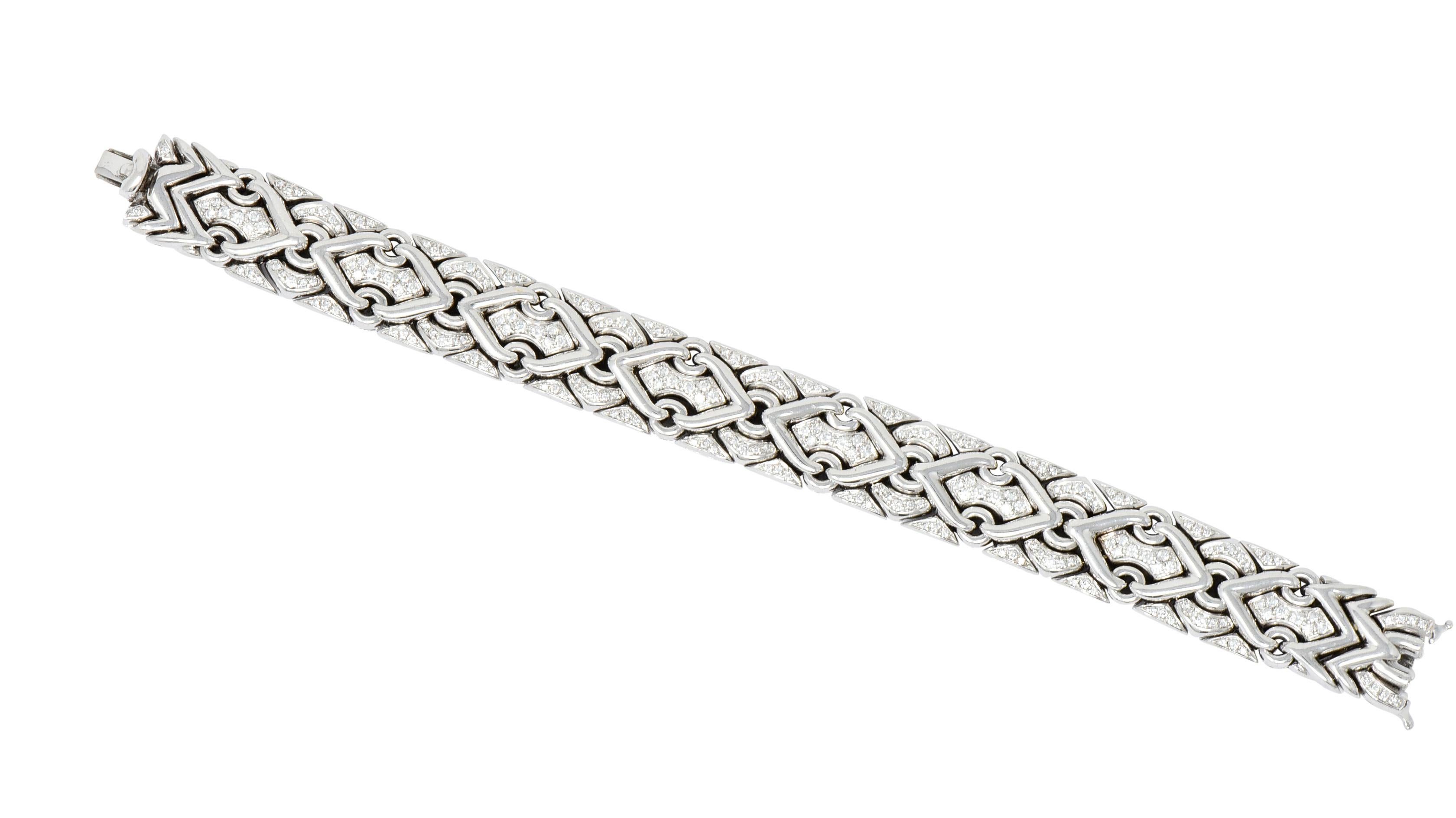 Link style bracelet featuring polished circle motif throughout, each connected by polished V motif

With rounded Moroccan style links, set throughout with round brilliant cut diamonds weighing approximately 2.40 carat total, G/H color and VS