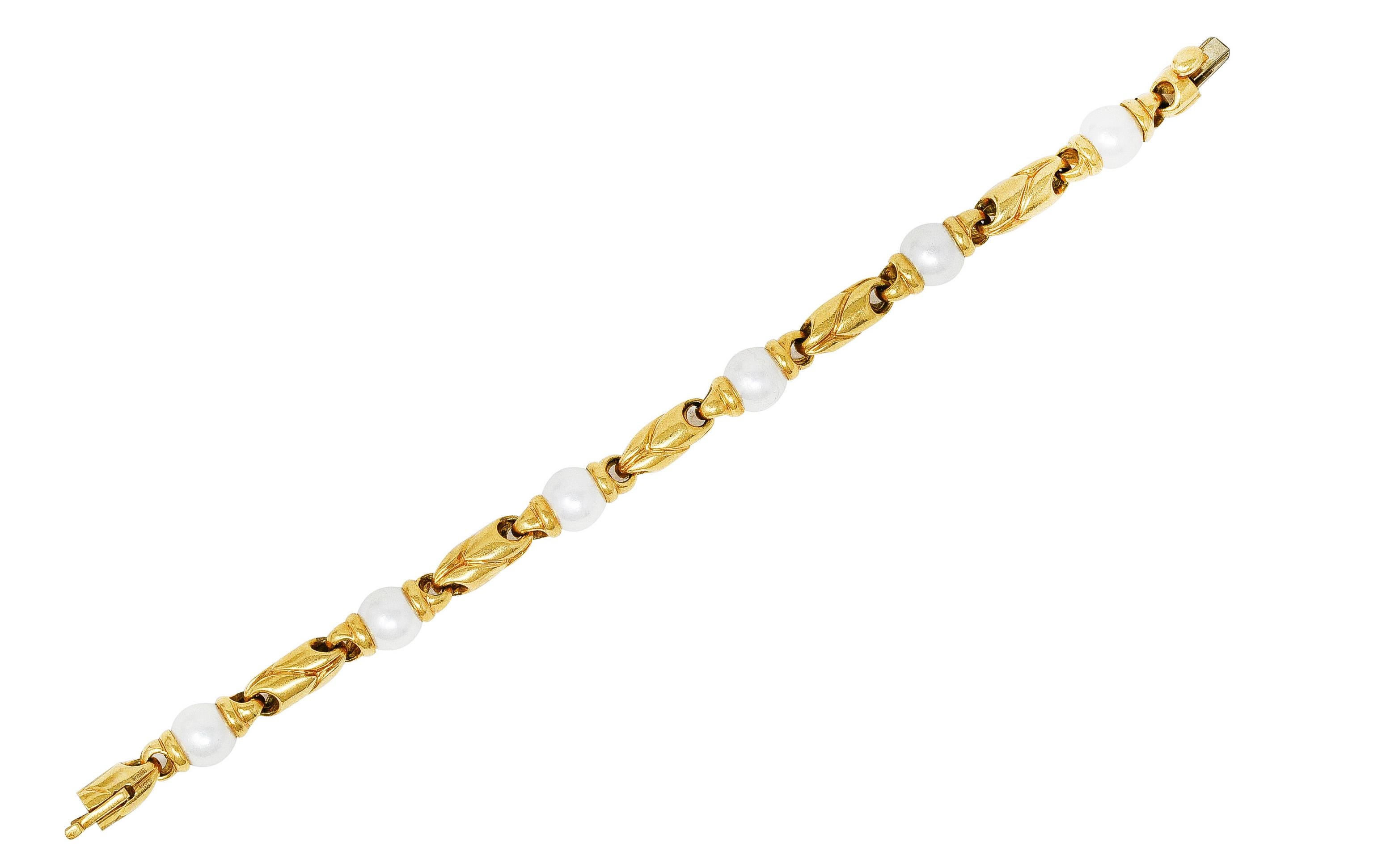 Bracelet is comprised of deeply grooved Passo Doppio gold links. Alternating with 8.0 mm round pearls set between gold terminals. White body color with rosé overtones and very good luster. Completed by hidden clasp closure with hinged safety.
