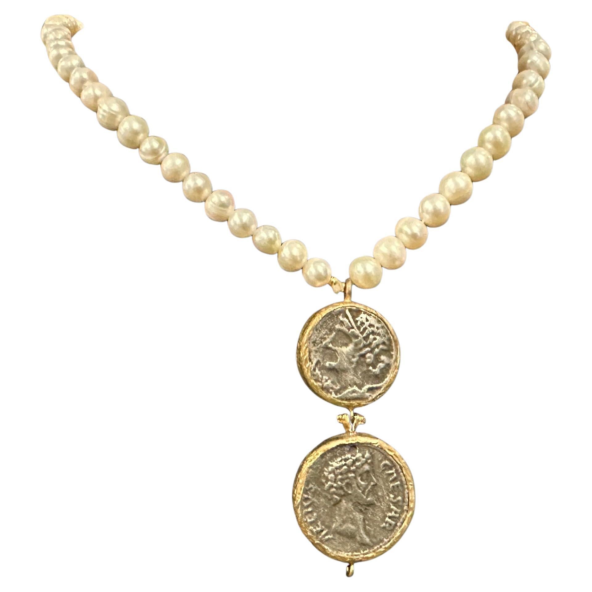 The necklace is composed of natural river pearls, which are irregular in shape, giving the piece a textured and organic look. These pearls are lustrous and slightly varied in size, emphasizing their natural origin and enhancing the vintage