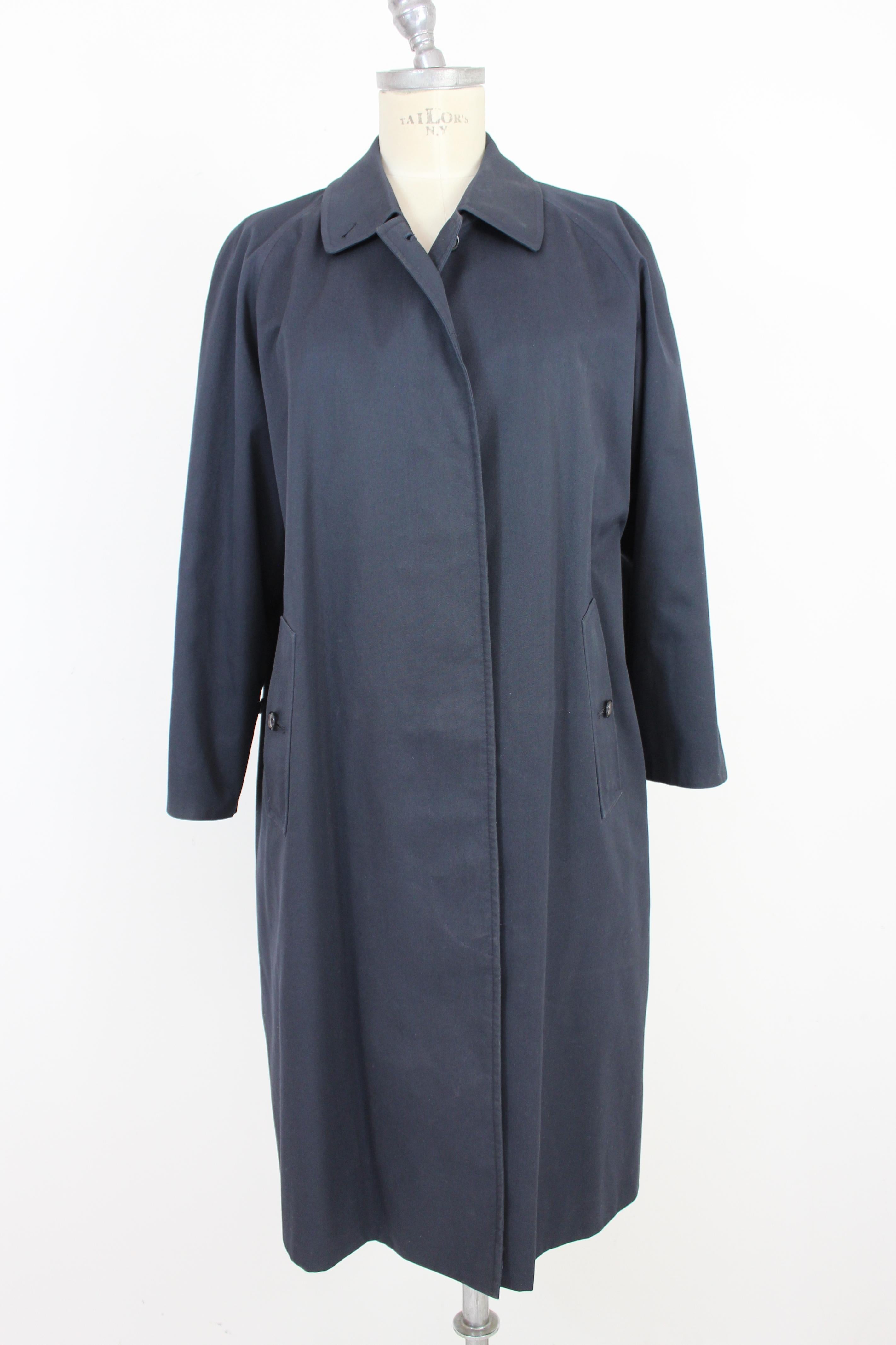 Burberry 80s vintage women's coat. Classic, long, blue raincoat. Fabric 51% cotton 49% polyester. Made in Italy.

Condition: Excellent

This item has been used a few times but remains in excellent condition. There are no visible signs of wear, and