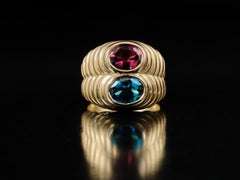 1980s Bvlgari 18 karat gold blue topaz and rhodolite doppio ring