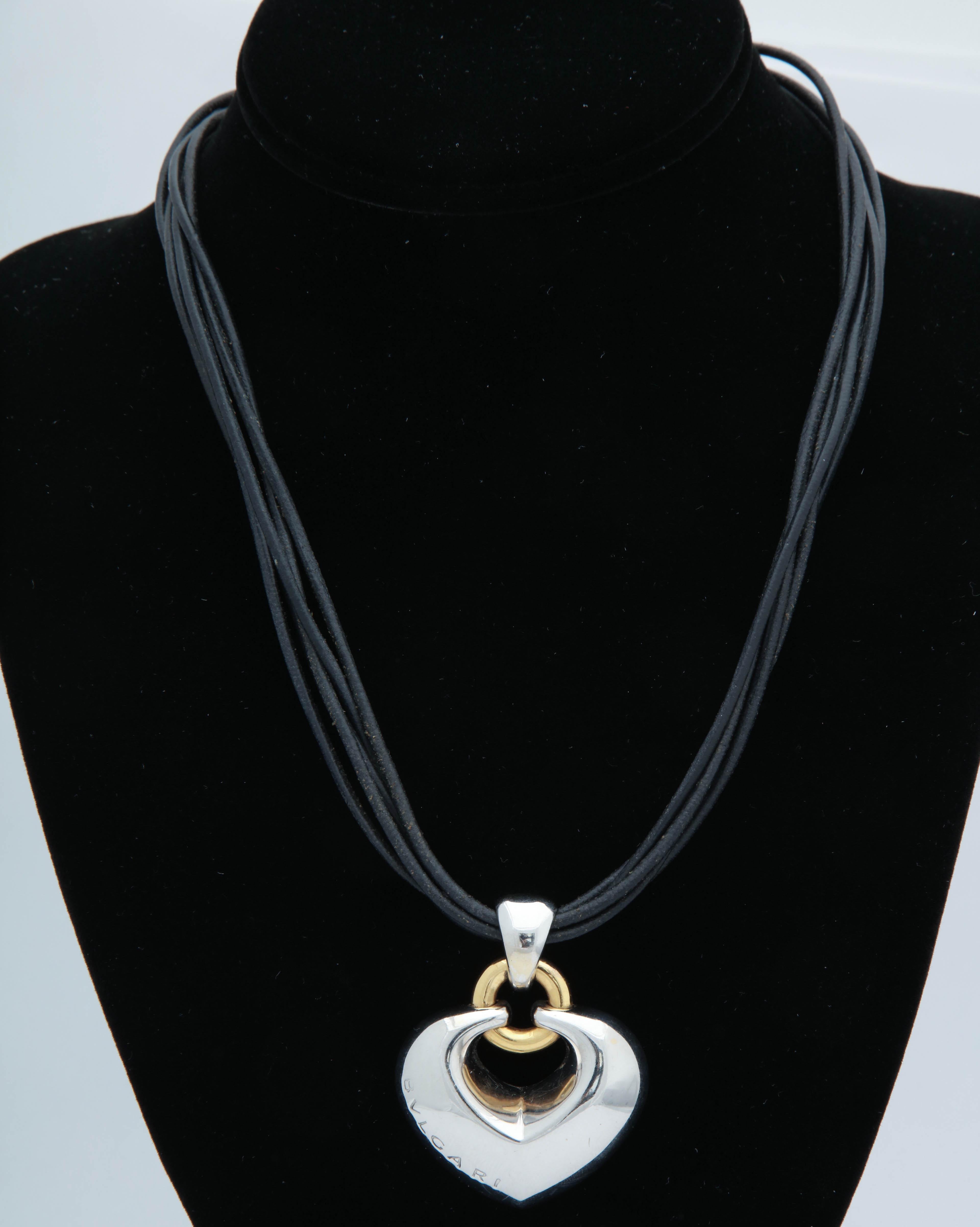 One Bulgari Heart Pendant Necklace Created In 18kt White And Yellow Gold And Hanging Five A Five Row Black Leather Cord Pieces. Designed With An Easy To Use 18kt White Gold Large Lobster Clasp.. Signed Bulgari On Clasp And On Heart Pendant. Created
