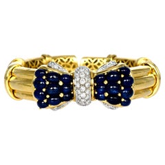 1980's Cabochon Blue Sapphire Diamond 18K Gold Bow Cuff Bangle Bracelet