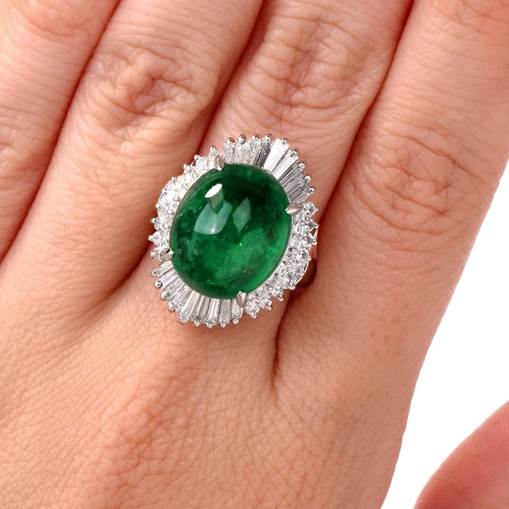 his captivating estate ballerina cocktail ring is crafted in solid Platinum and weighs approximately 13.12 grams. It is centered with a genuine GIA certified oval cabochon Emerald of approx. 12.23ct (15.12 x 12.70 x 9.10mm). The ballerina pattern is