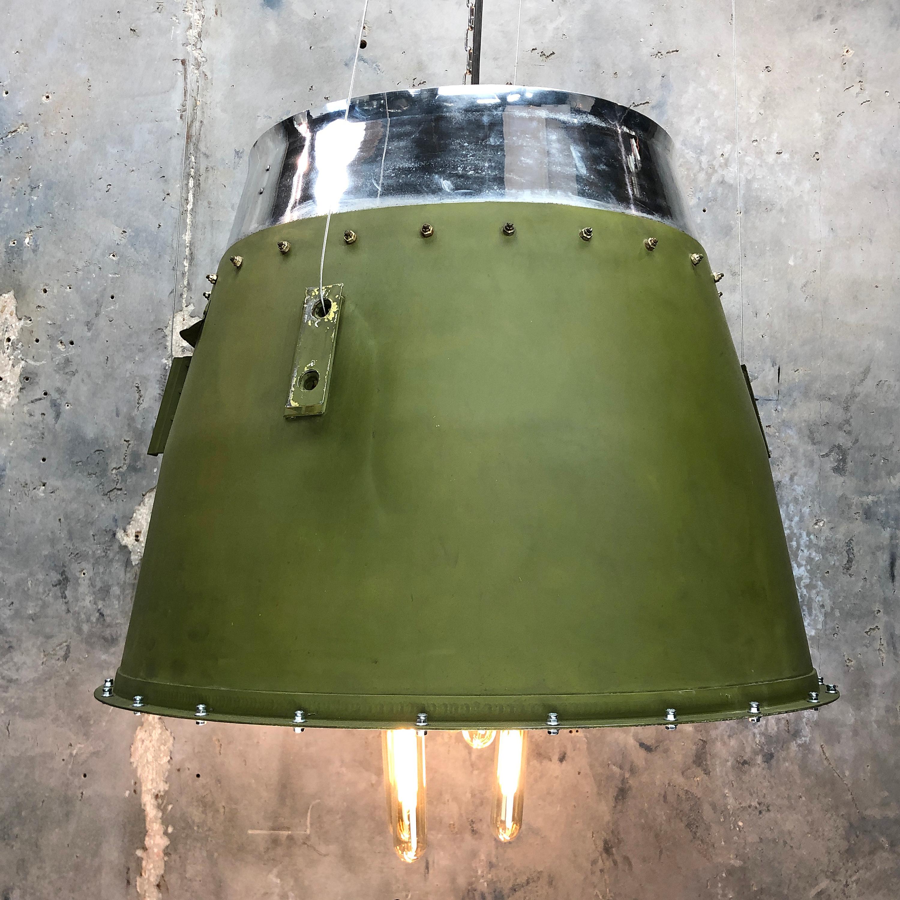 A reclaimed green jet engine cowling from a bombardier Learjet business aircraft which has been recycled and converted into a large ceiling pendant light.

This was originally found on the exhaust of the jet engine. We have both cowlings from the