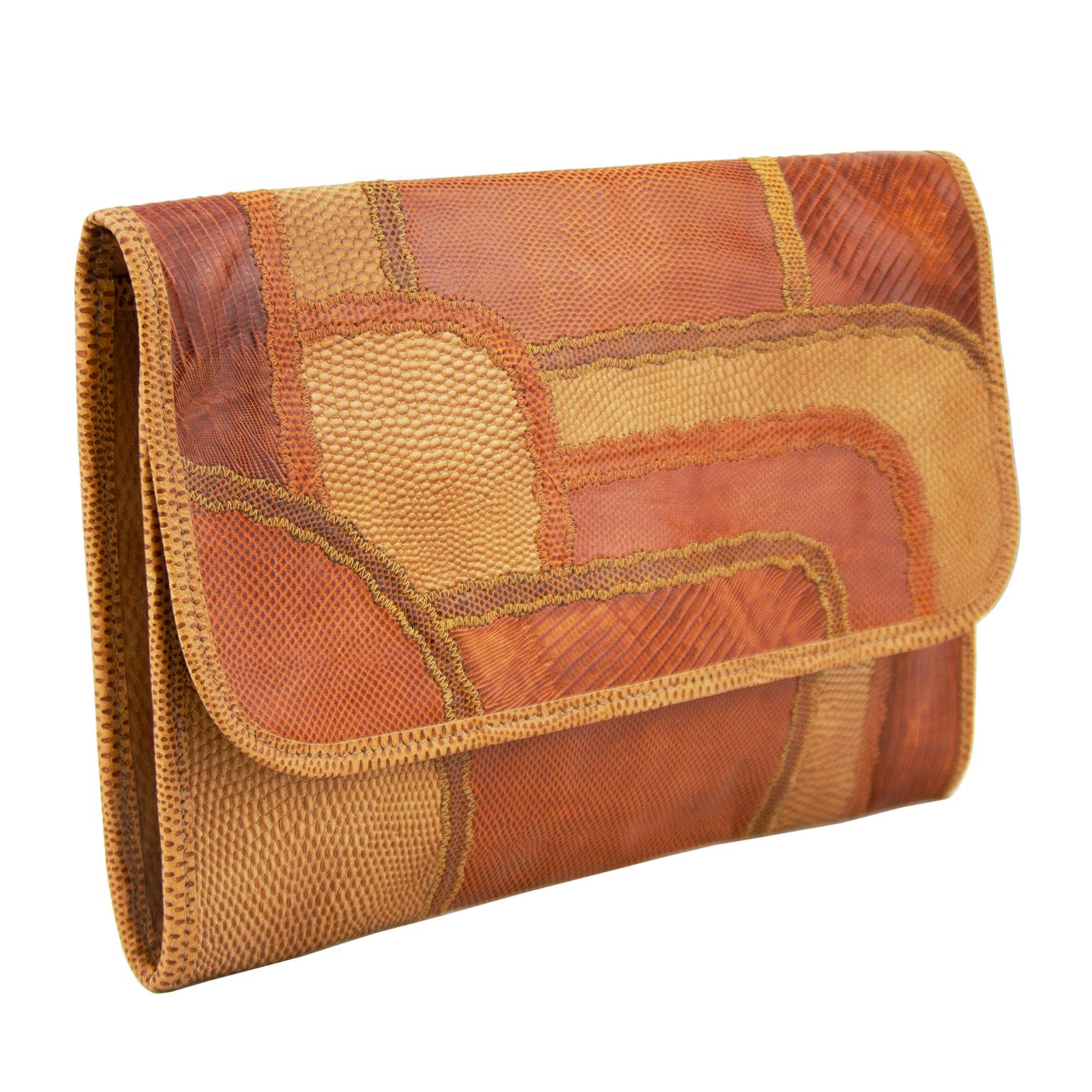 1980s Carlos Falchi tan and brown patchwork rectangular clutch. Envelope style with flap front with gold snap closure. Brown leather interior with single interior slip pocket with zipper. Excellent vintage condition. 12