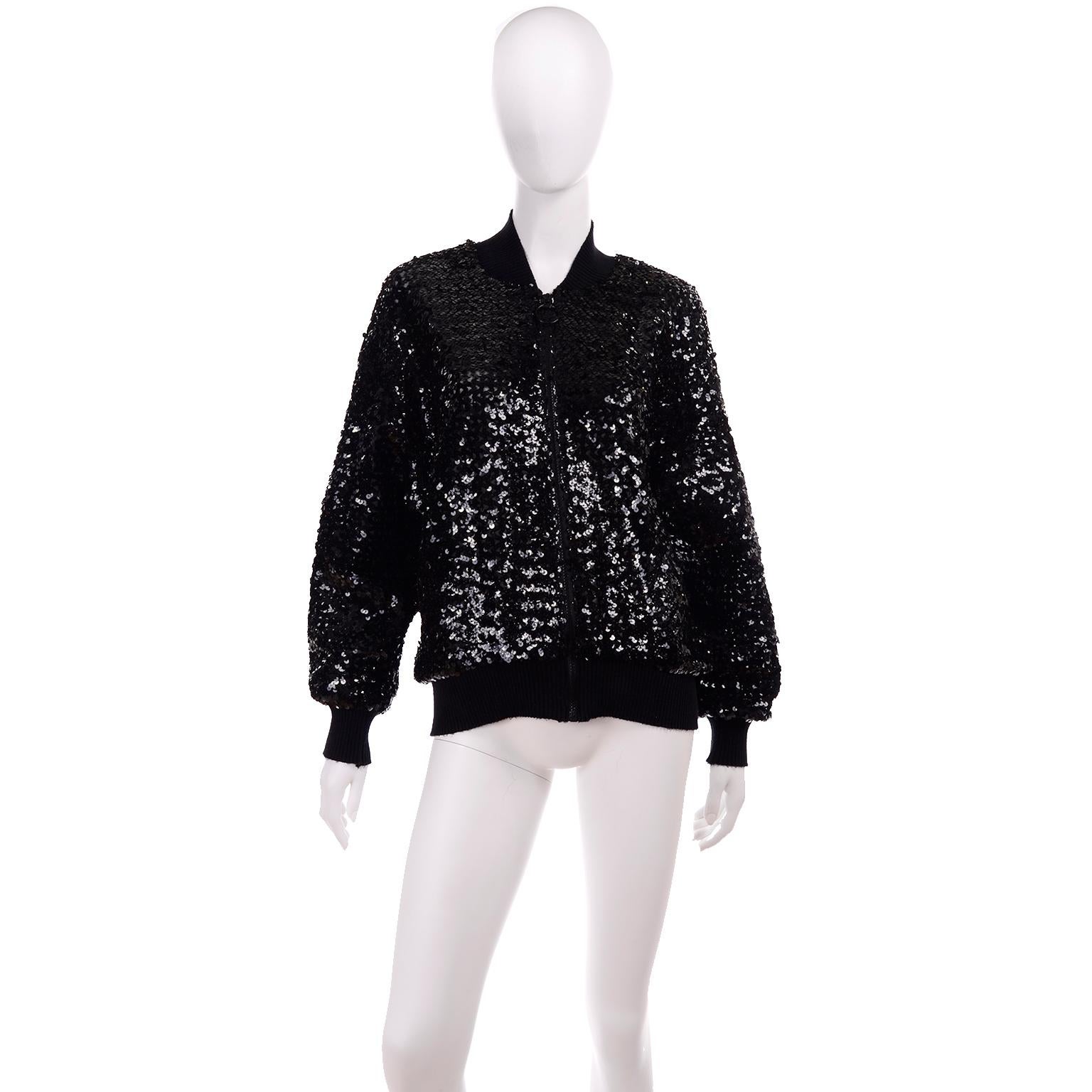 This is such a great black sequin bomber jacket style zip front top that was made in U.S.A by  Caron Chicago in the 1980's. The front has a metal zipper with a metal ring and there are elastic knit cuffs and an elastic knit waistband. The jacket has