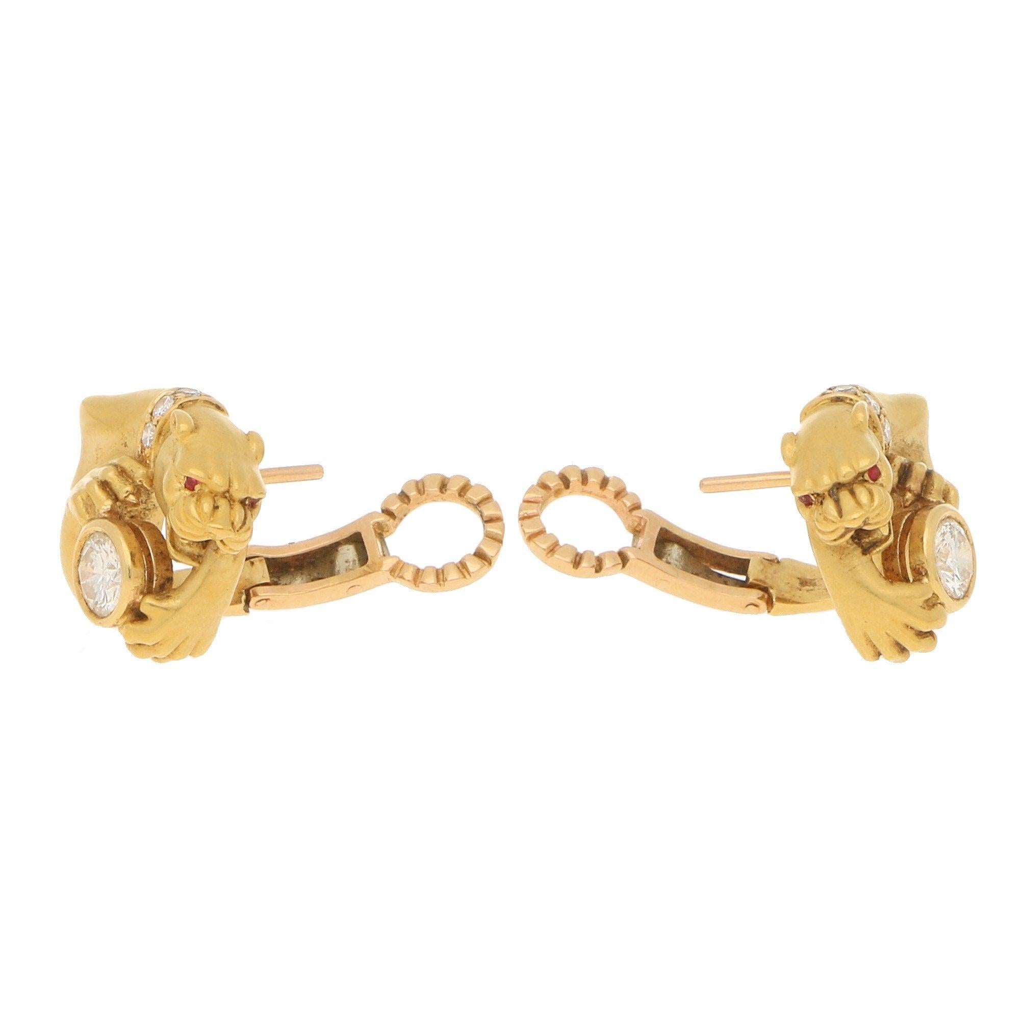 A pair of Carrera y Carrera diamond panther earrings in 18-karat yellow gold, circa 1980. Each earring is depicted as a panther pouching on a collet-set round brilliant-cut diamond, further accented with a round brilliant-cut diamond collar and