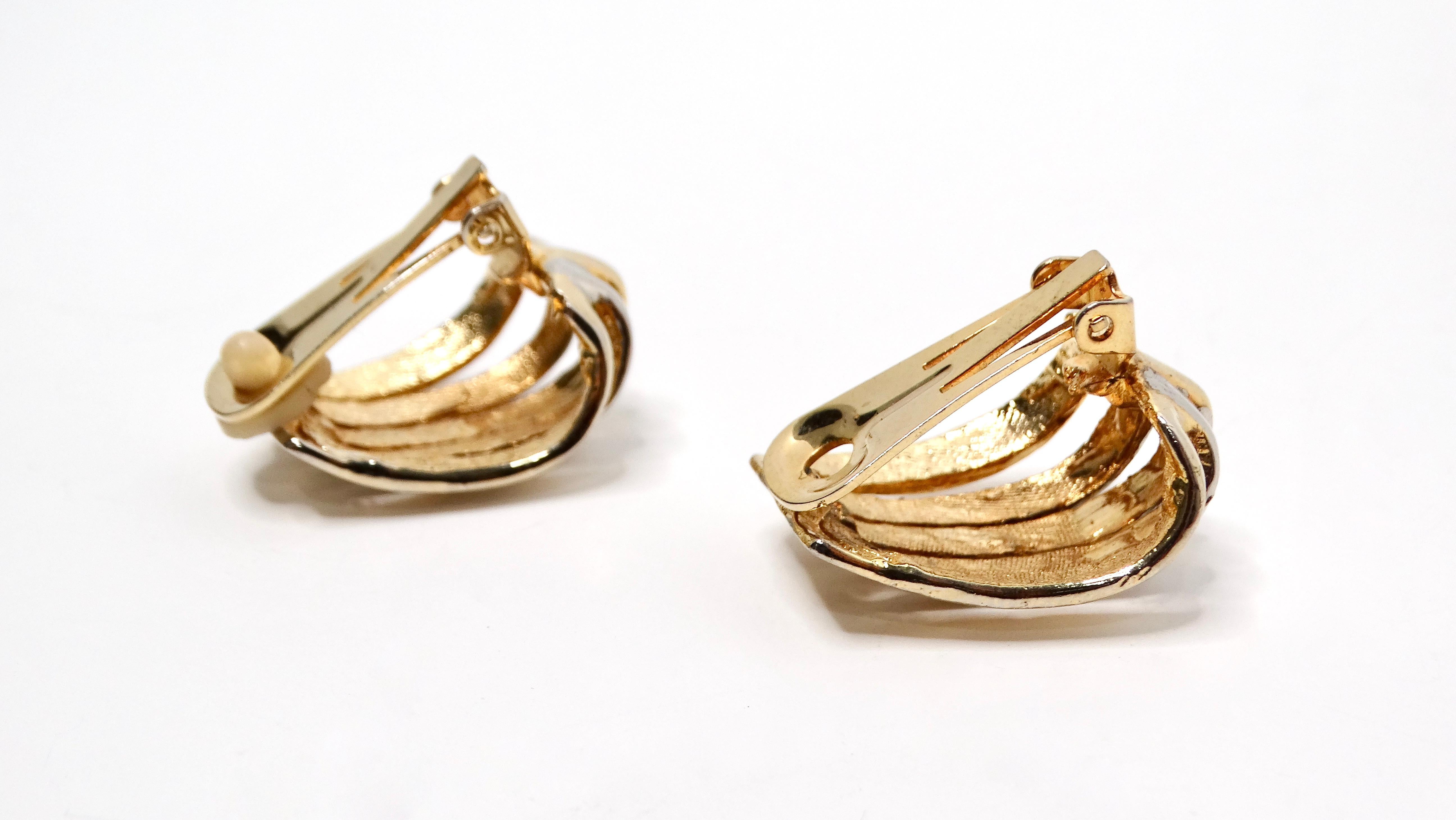 Introducing our exquisite 1980s Cartier Inspired Sculpted Two-Tone 14k Gold Plated Clip-On Earrings. These striking earrings feature a bold silver and goldstone striped design, ingeniously carved into elegant curves that enhance their oversized