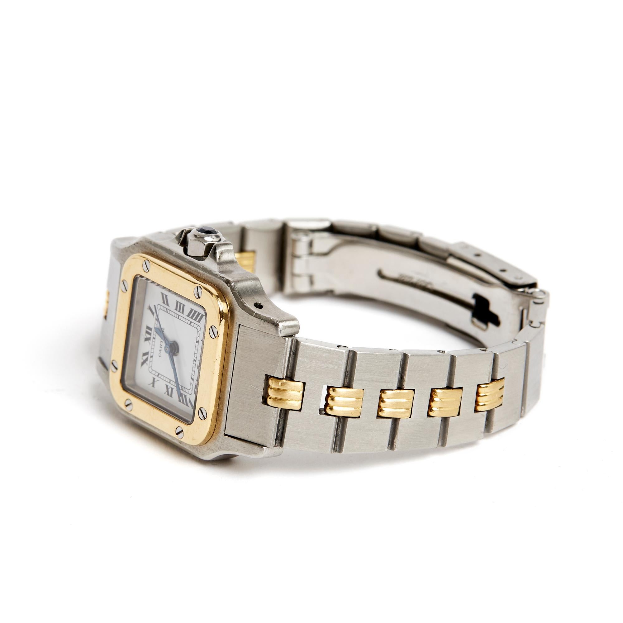 Cartier Santos Lady model watch late 1970, early 1980, in steel and 18K yellow gold, automatic, white dial with railway and Roman numerals, adjustable steel and yellow gold bracelet and folding clasp, crown fitted with a faceted spinel cabochon ,