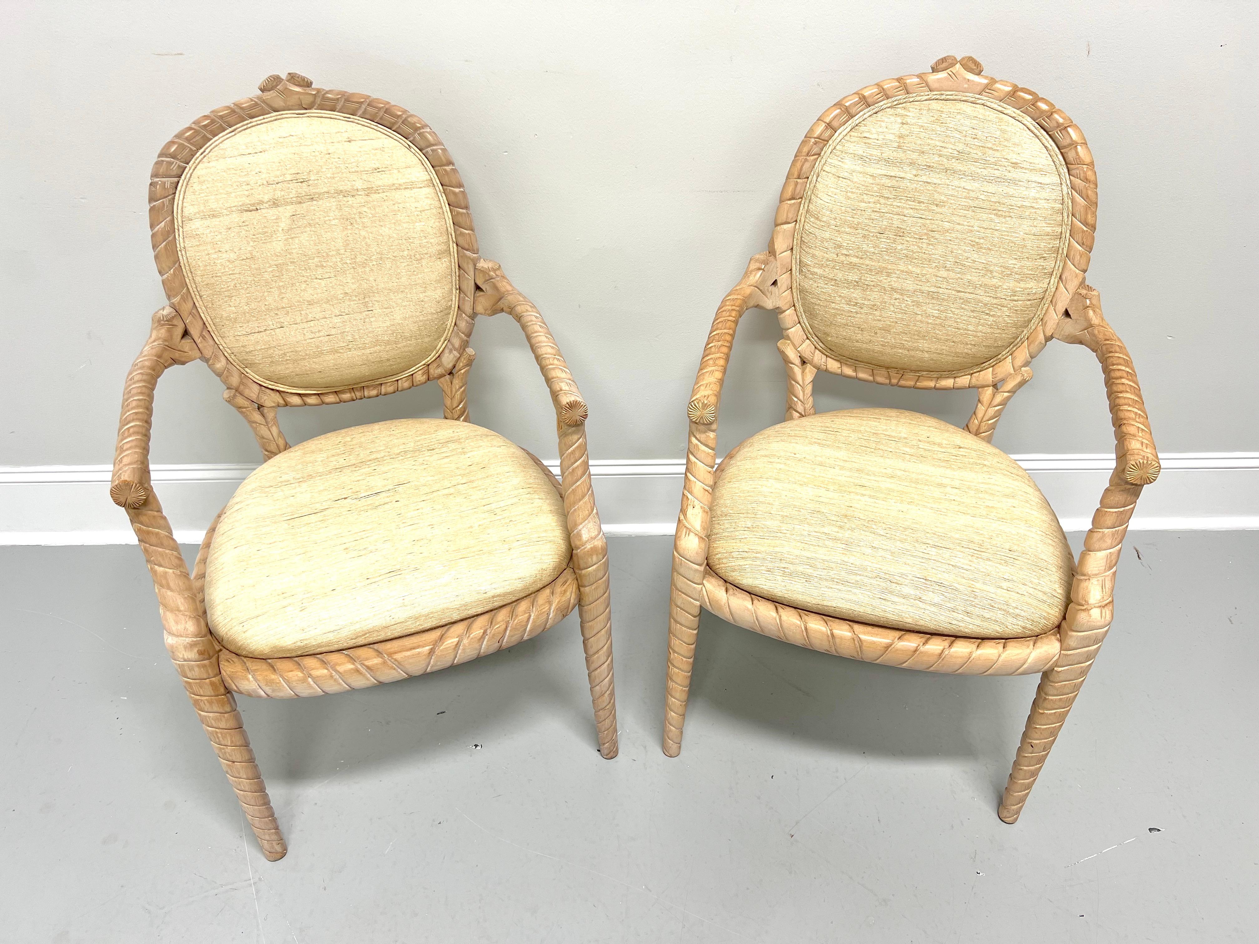 A pair of dining armchairs in the Boho Chic style, unbranded. Solid hardwood with whitewashed & distressed finish, decoratively carved rope twist to the oval shaped backrest, the curved arms, the apron, and tapered straight legs. Chair backs and