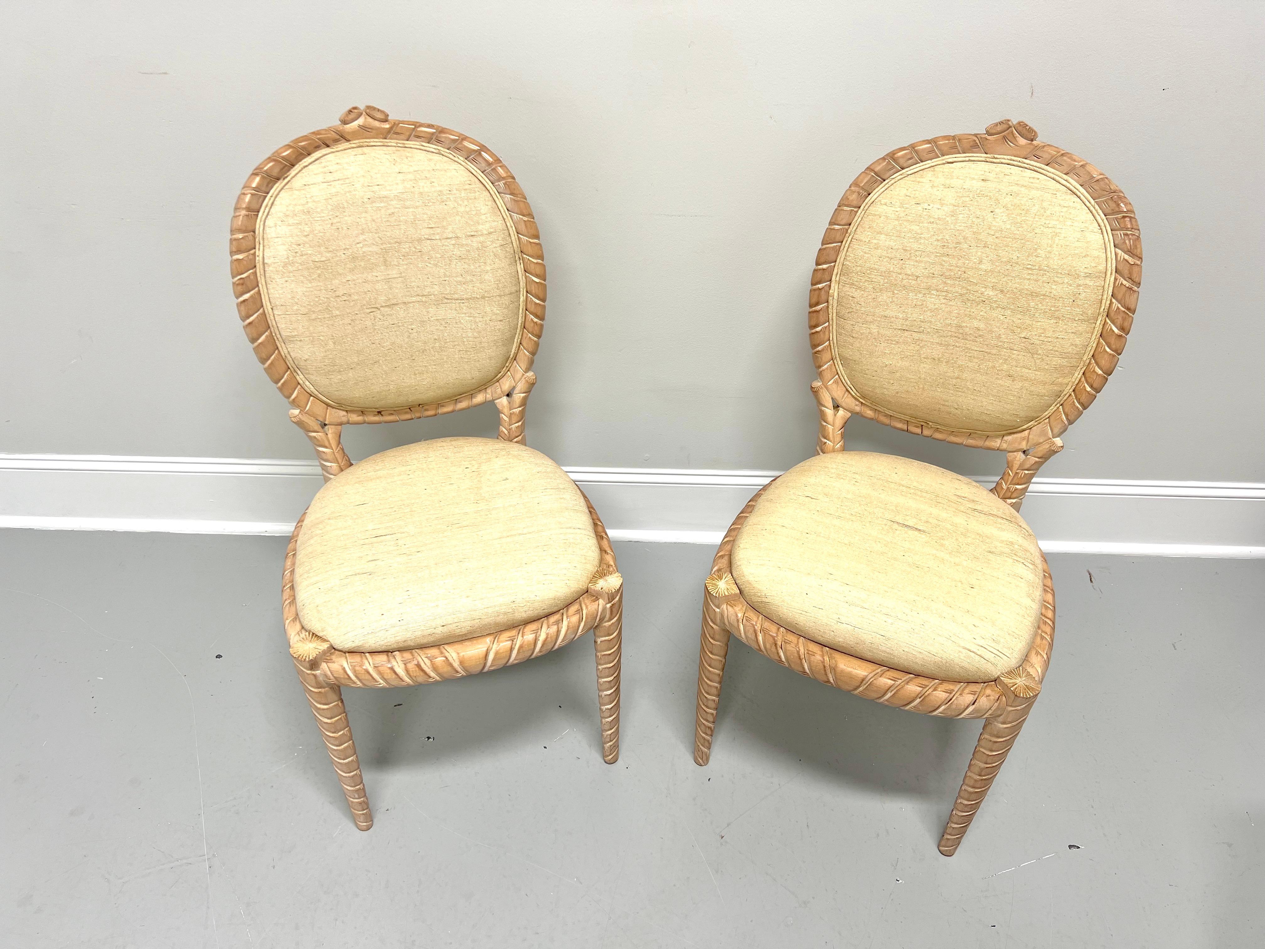 A pair of dining side chairs in the Boho Chic style, unbranded. Solid hardwood with whitewashed & distressed finish, decoratively carved rope twist to the oval shaped backrest, the apron, and tapered straight legs. Chair backs and seats are