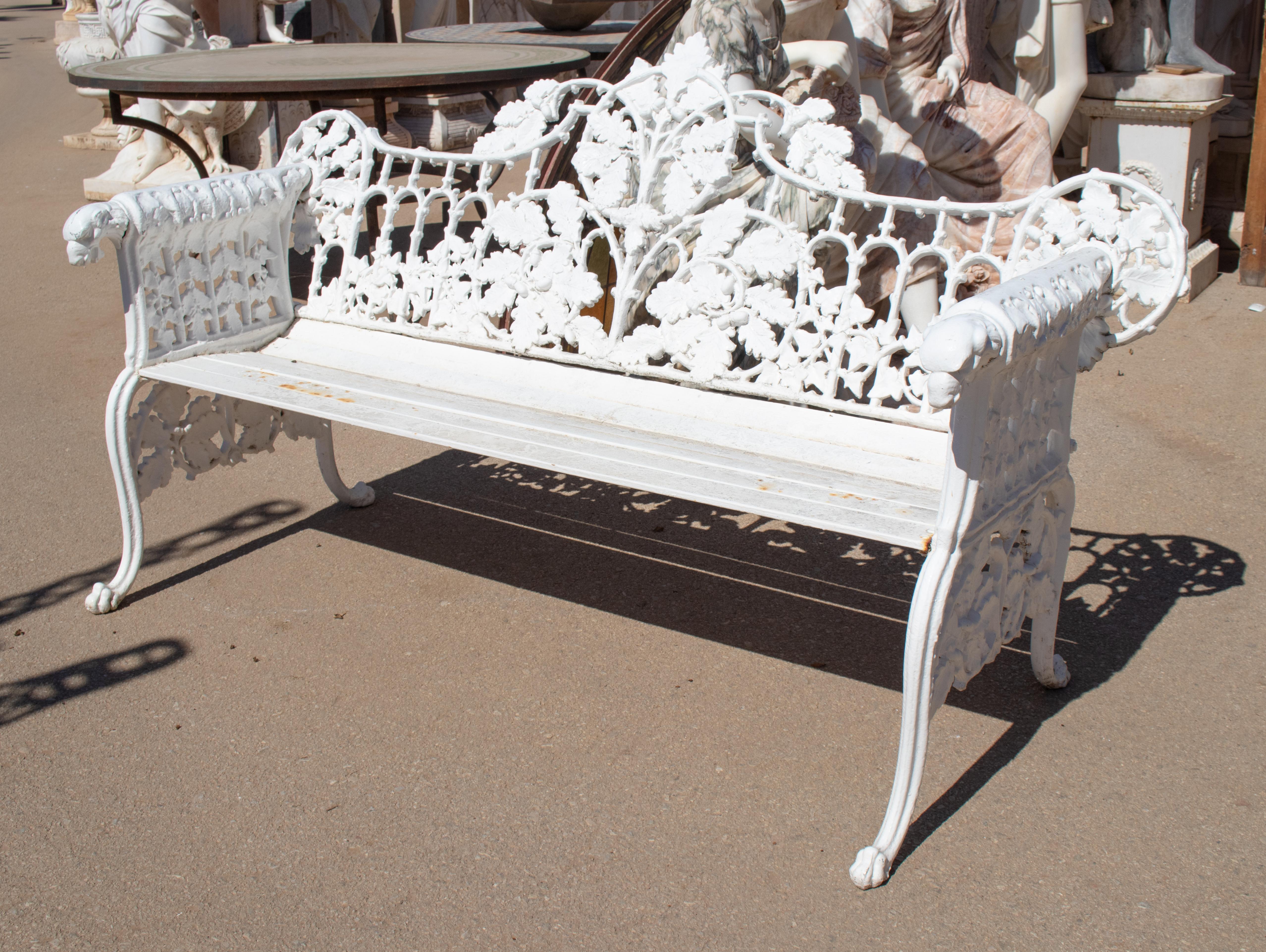 1980s cast aluminium solid metal white garden bench with grapes, flower garlands and animal head on armrests.