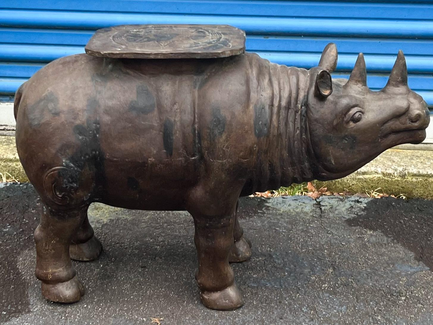 This is a late 20th century cast bronze rhinoceros side table / garden seat attributed to Maitland-Smith. What a conversation piece! He is unmarked and in very good condition.