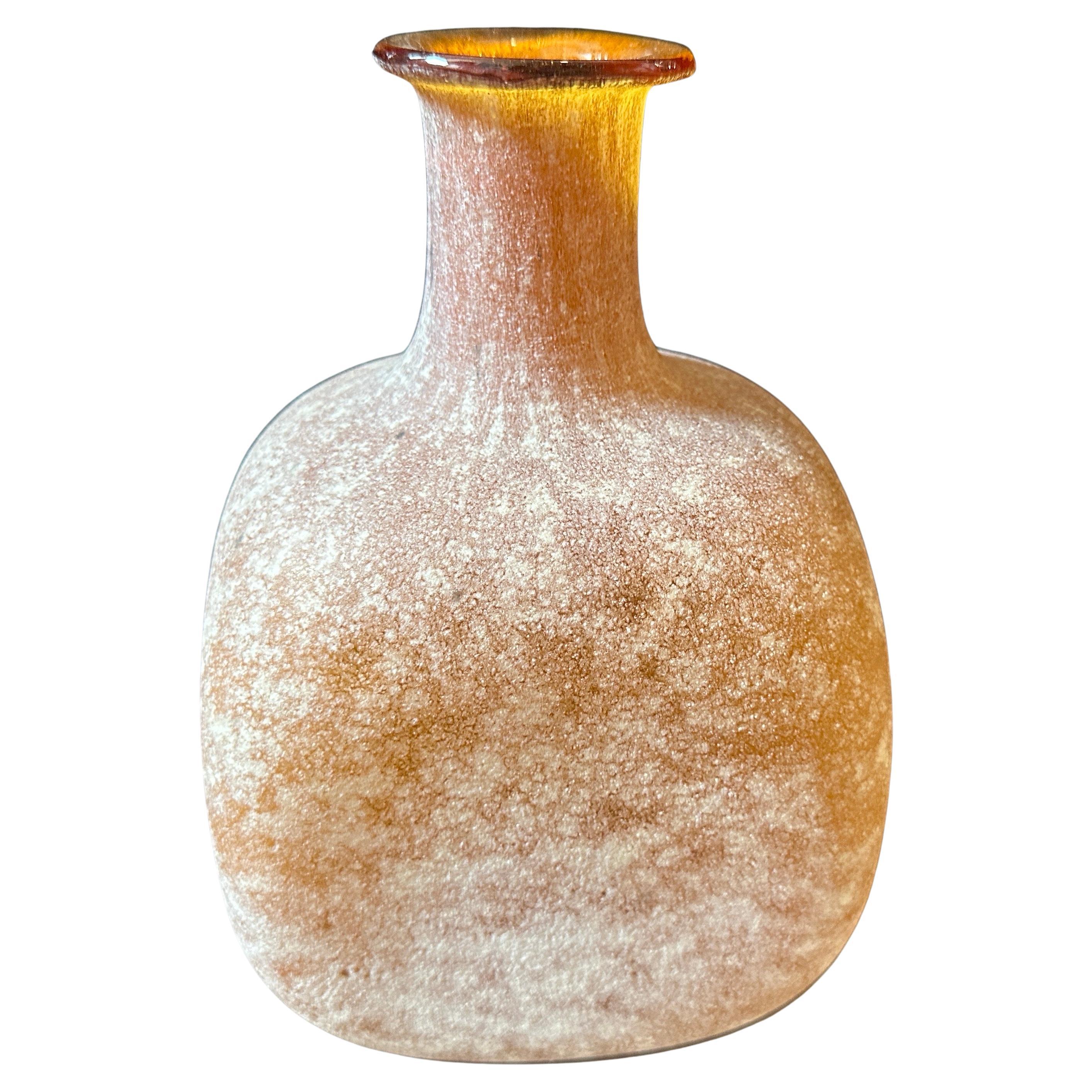 The yellow murano glass vase features a unique scavo (meaning 